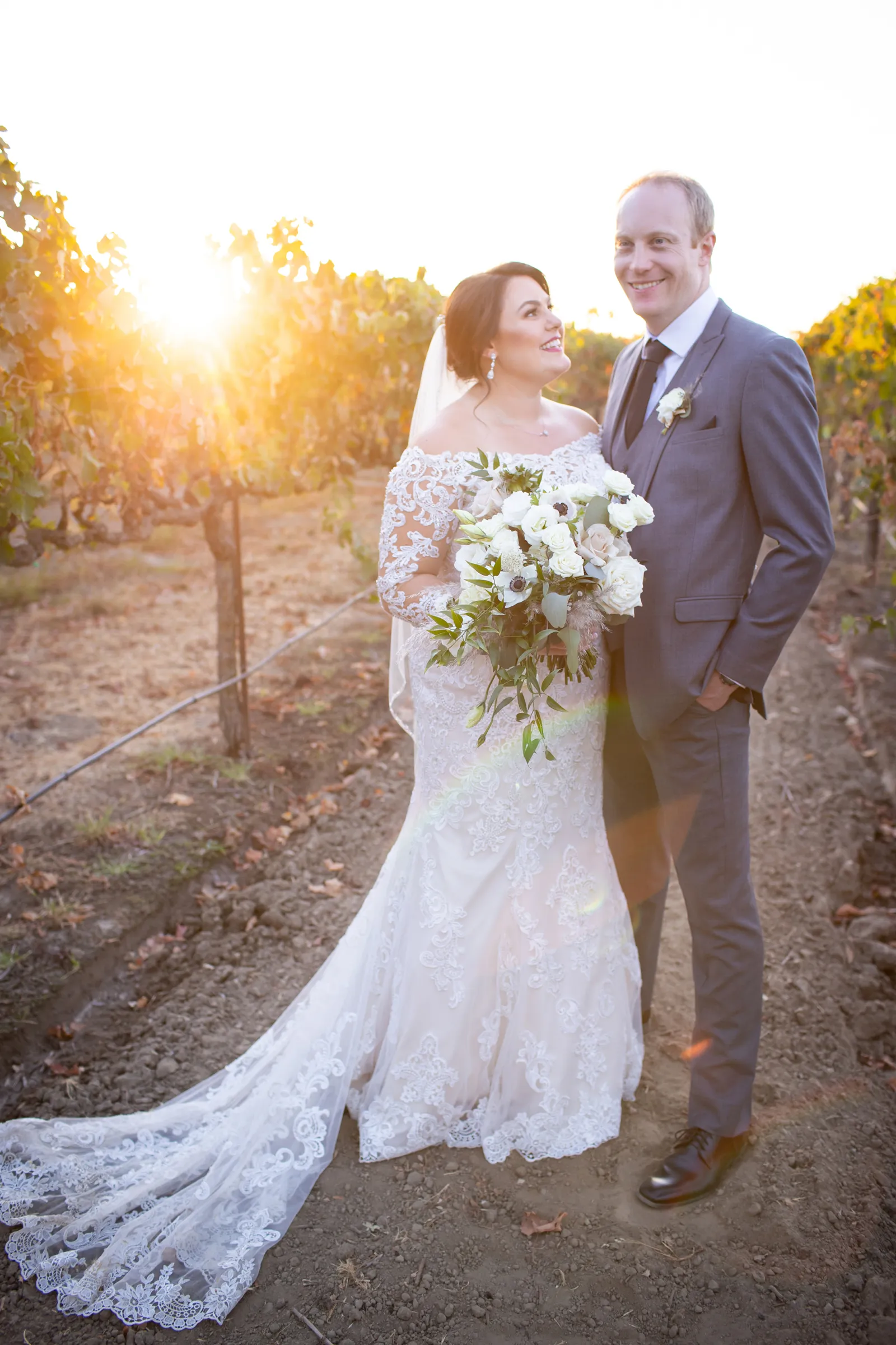 Newlyweds taking photos in vineyard