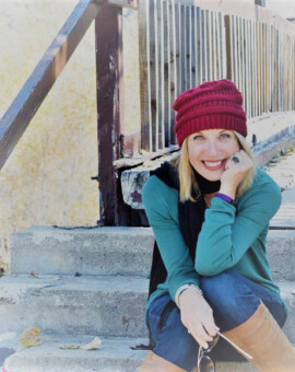 Woman sitting on stairs taking photos