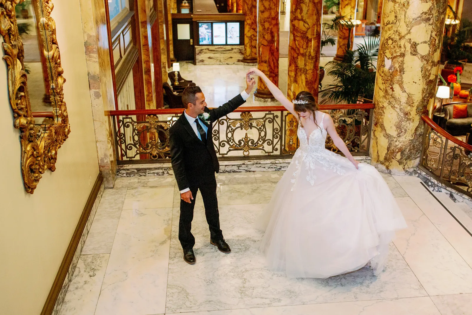 Newlyweds dancing on top of stairs