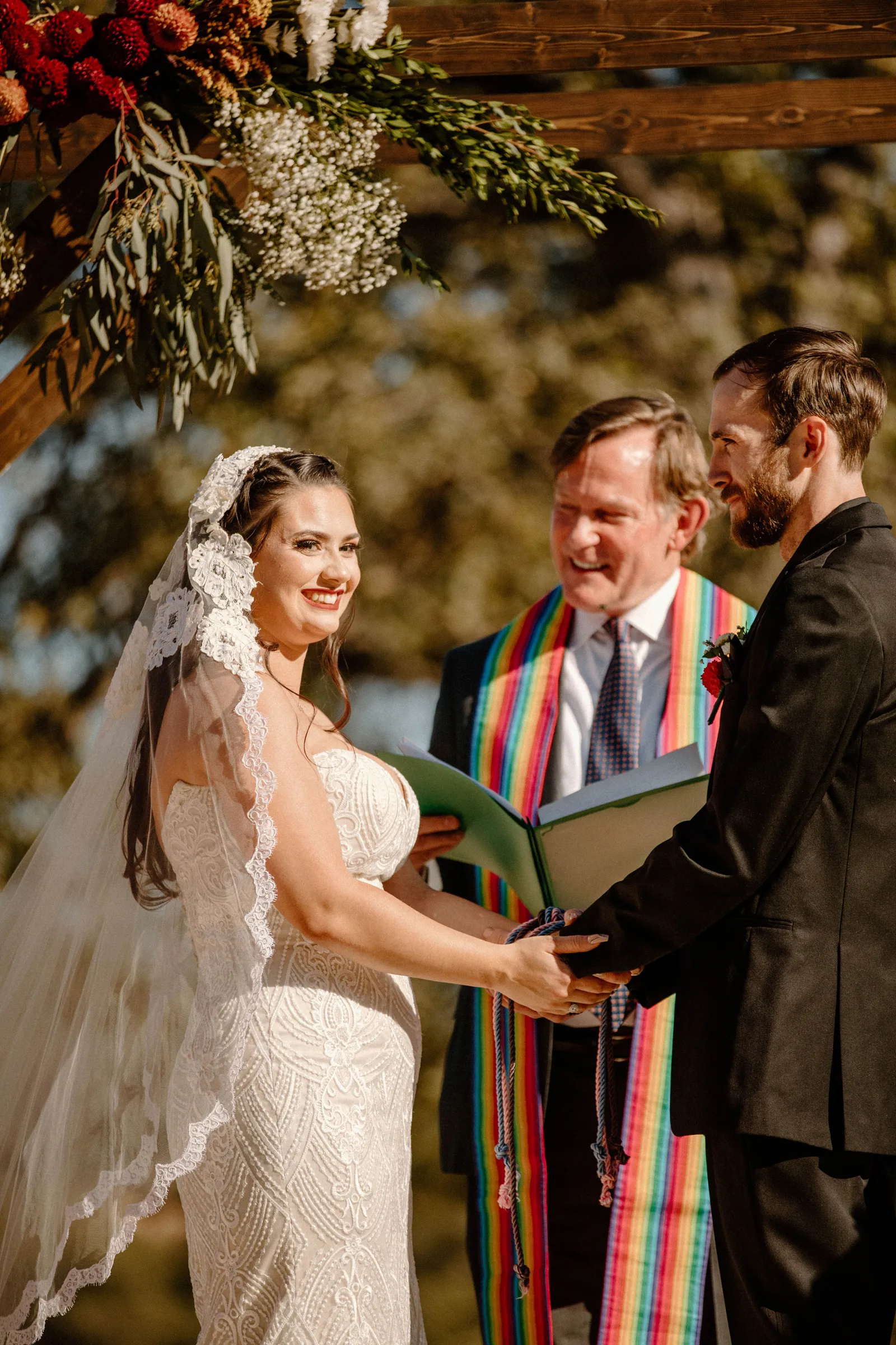 Bride and groom tying the knot with officiant