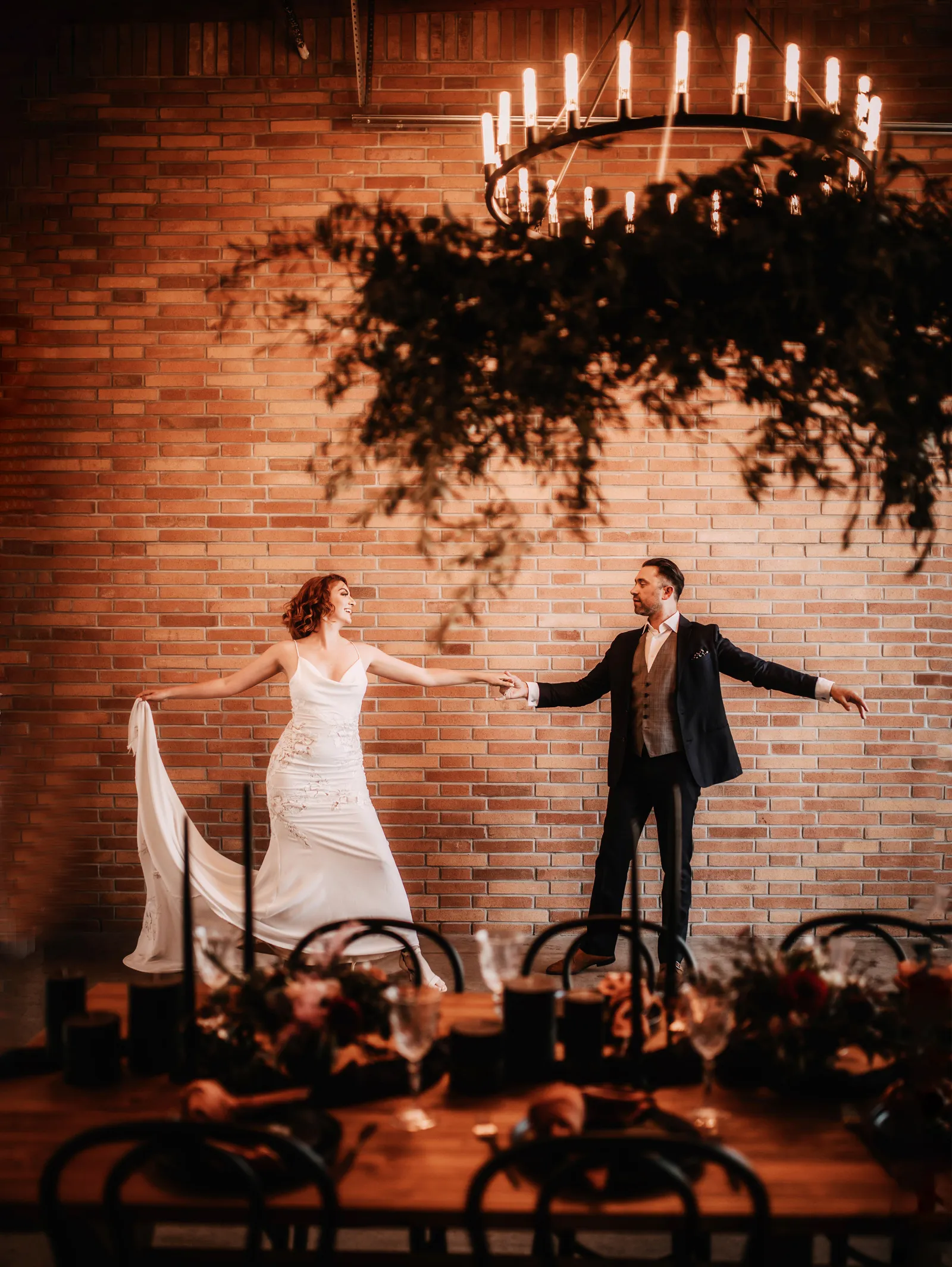 Couple dancing under chandalier