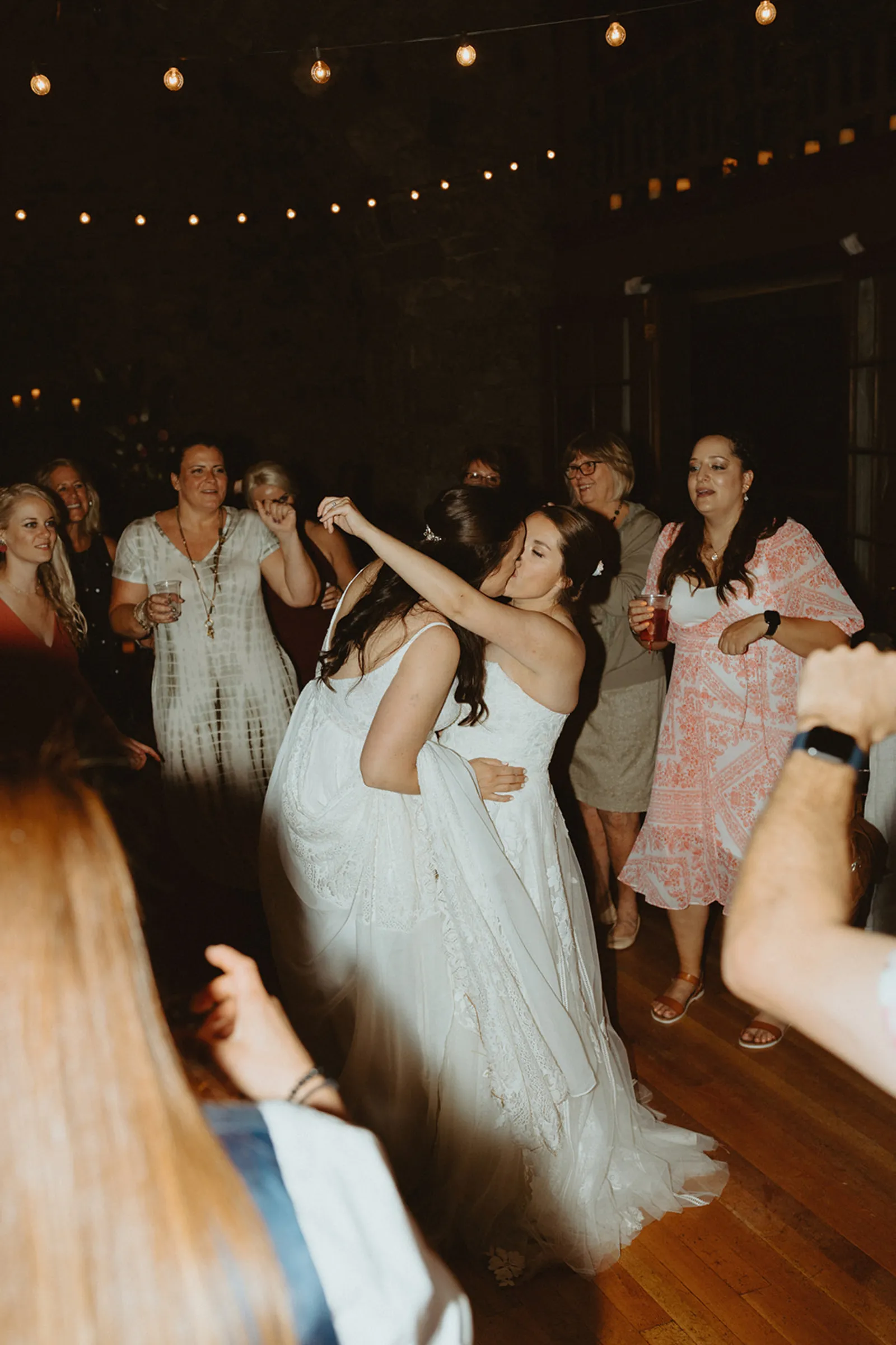 The newlyweds kissing on the dance floor