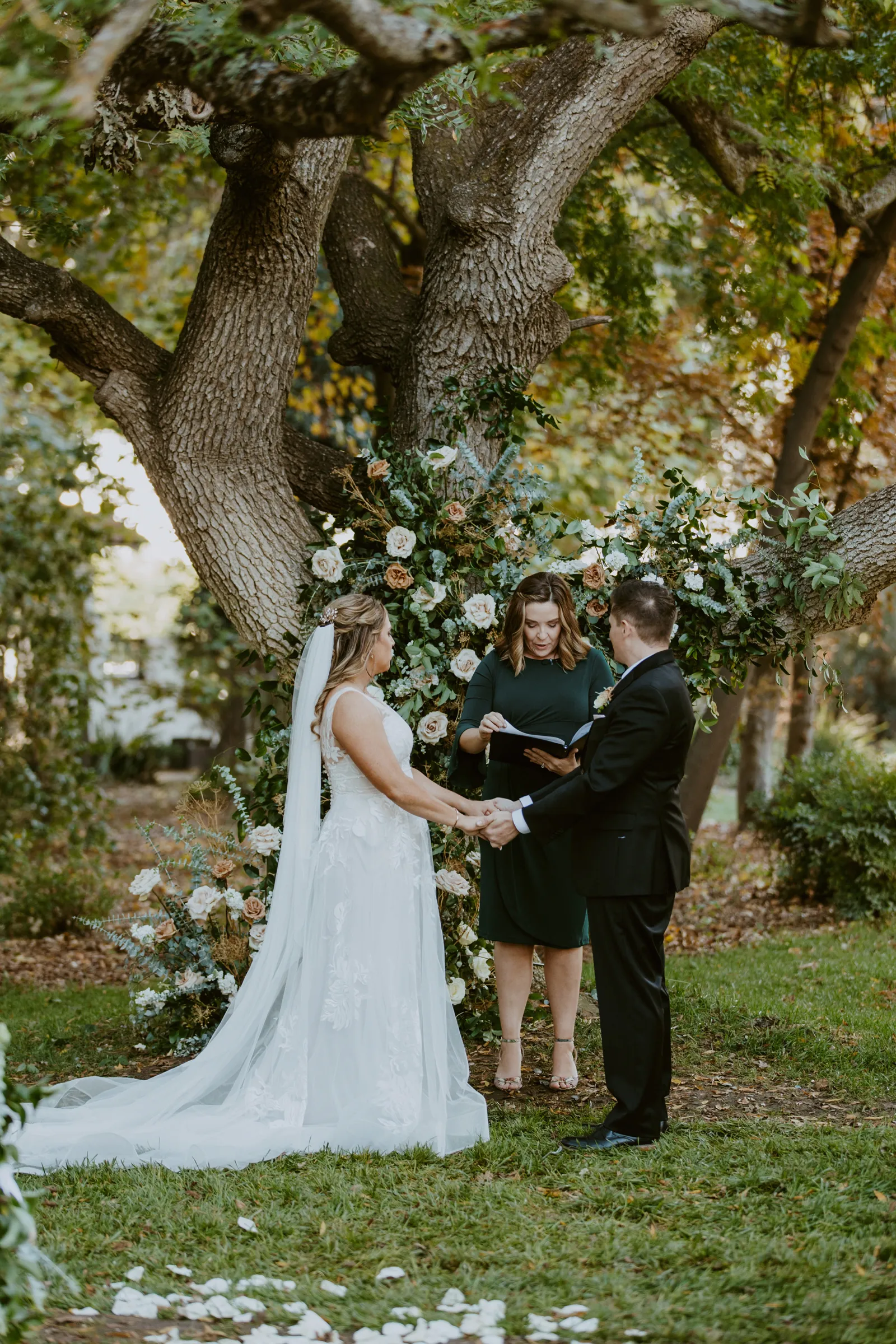 Bride and groom holding hands at the altar.