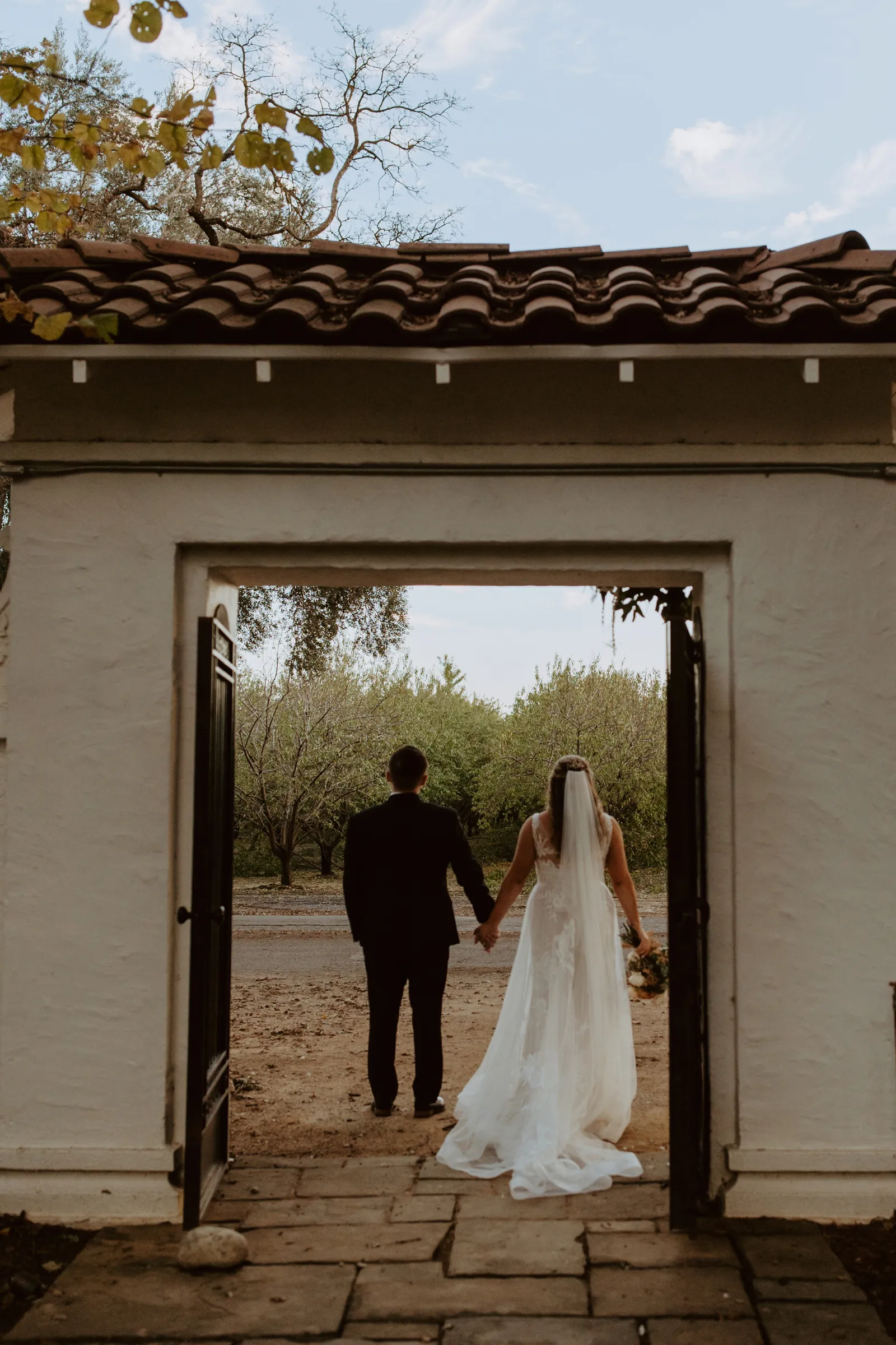 Bride and groom with their backs to the camera.