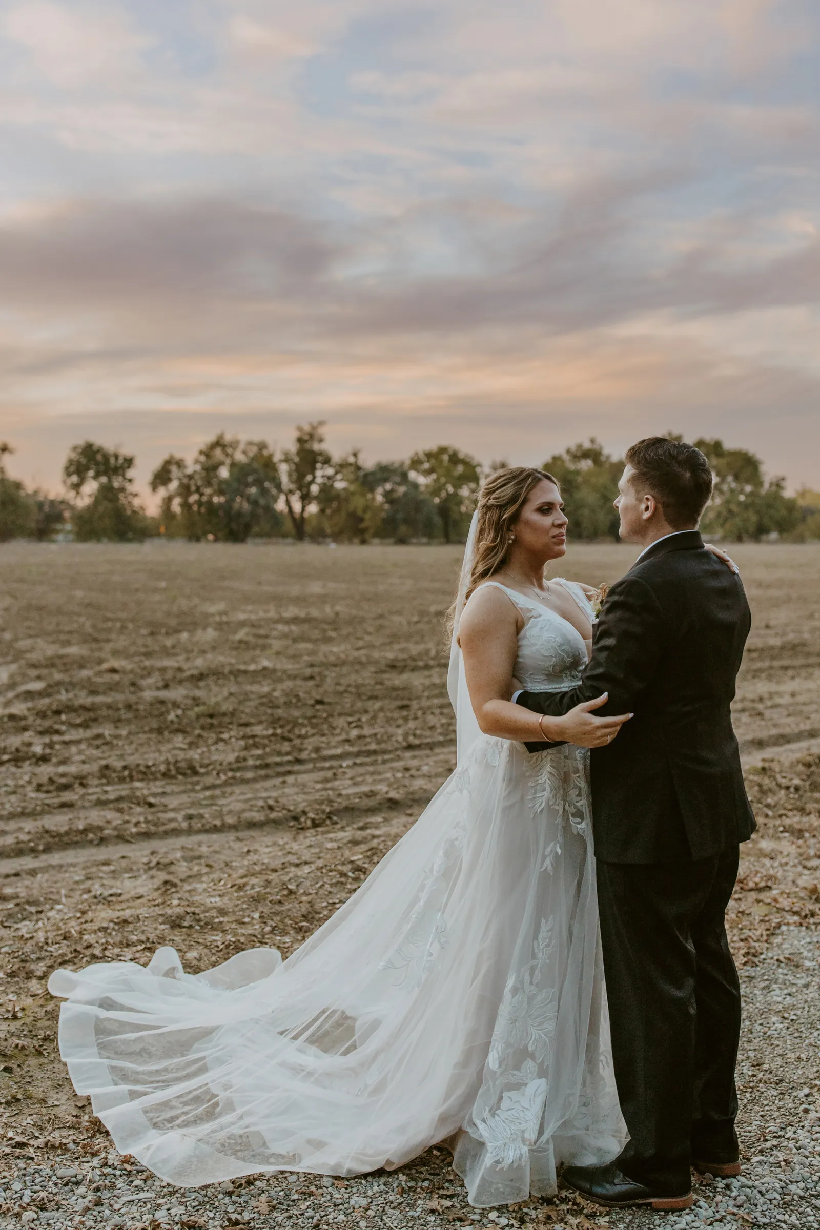 Bride and groom taking wedding photos outside