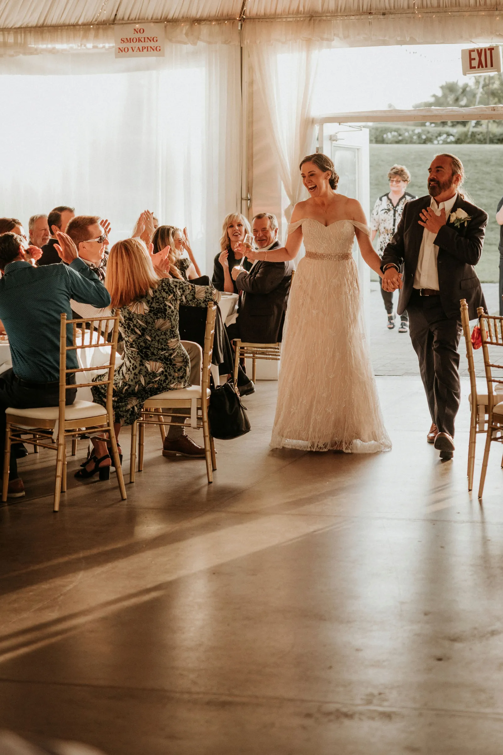 Newlyweds walking into the reception