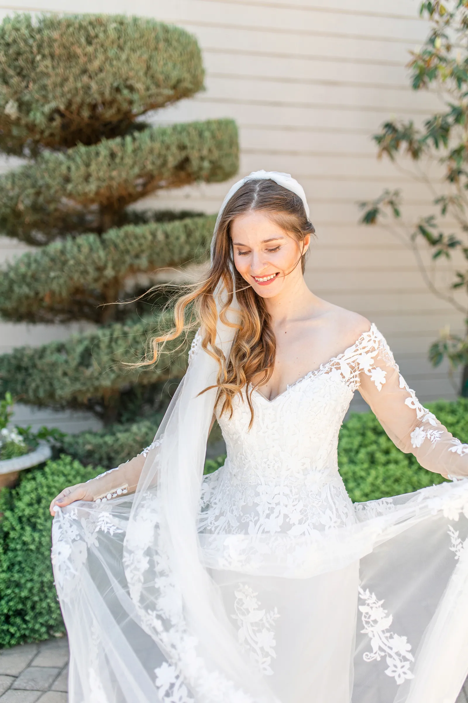 Bride picking up her gown and smiling