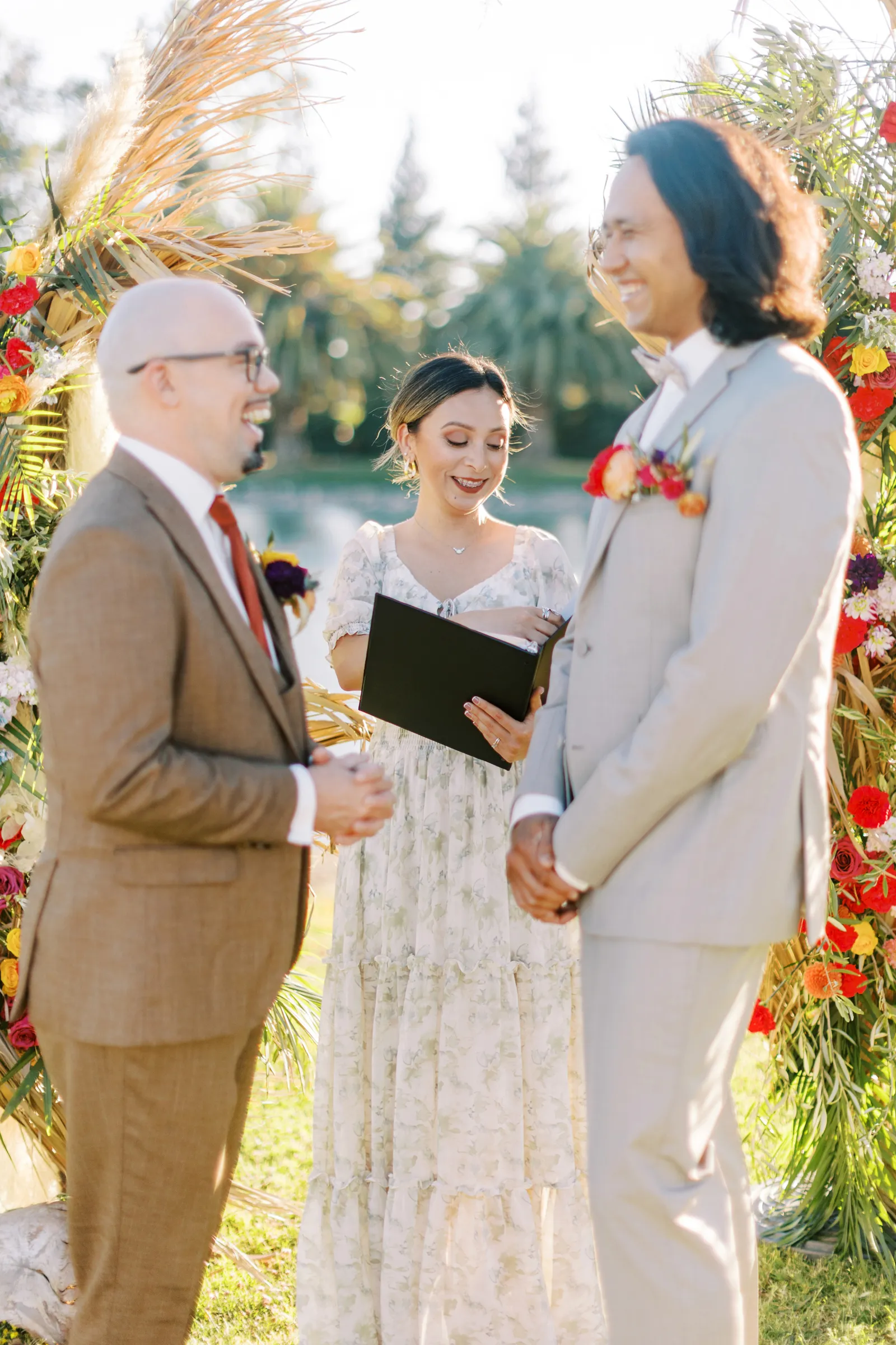 Men getting married by officiant outdoors