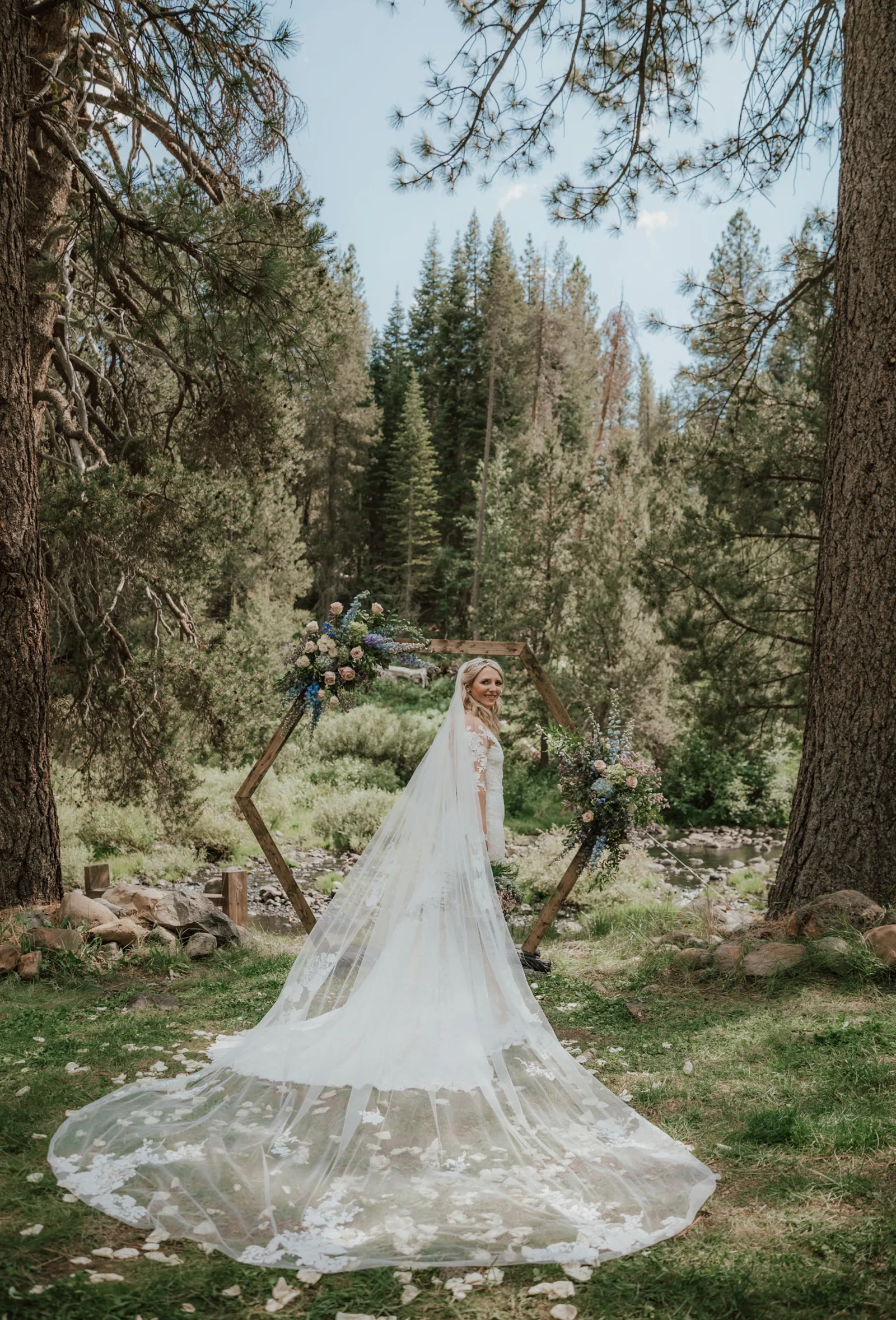 Photo of bride's long train by the outside altar