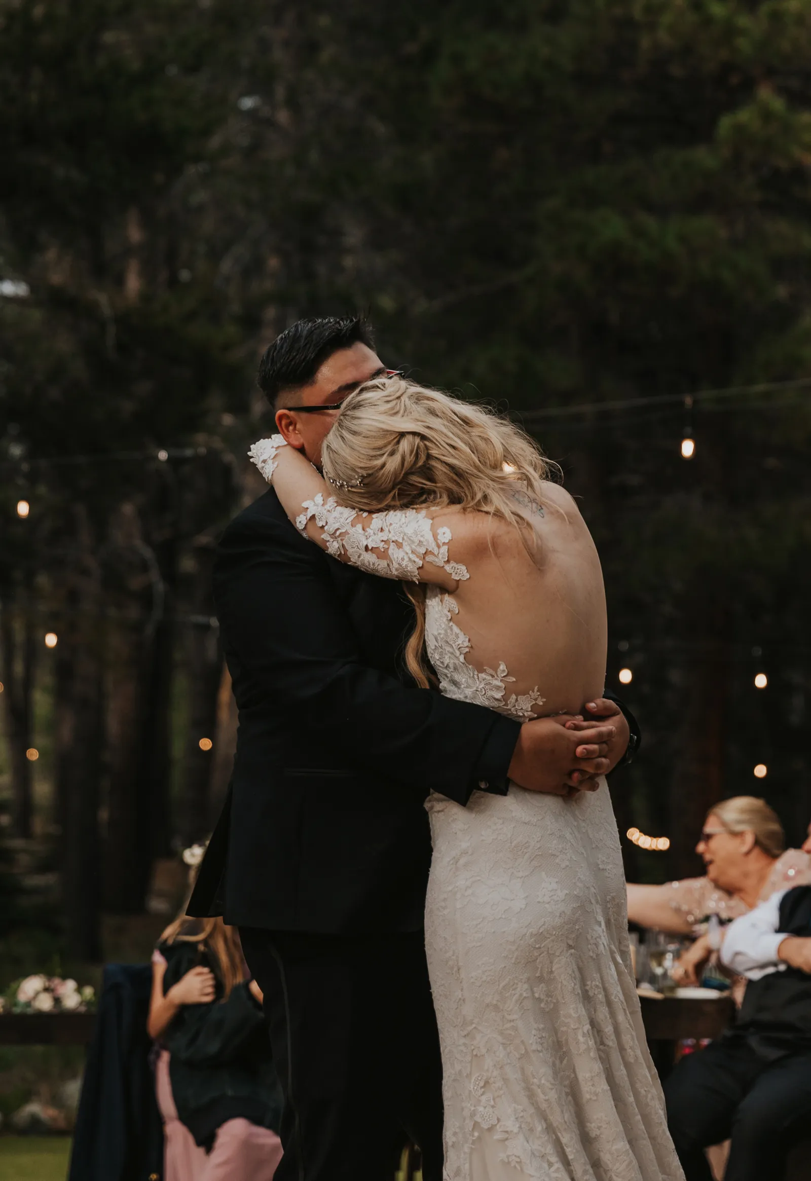 Bride hugging her groom during their first dance.