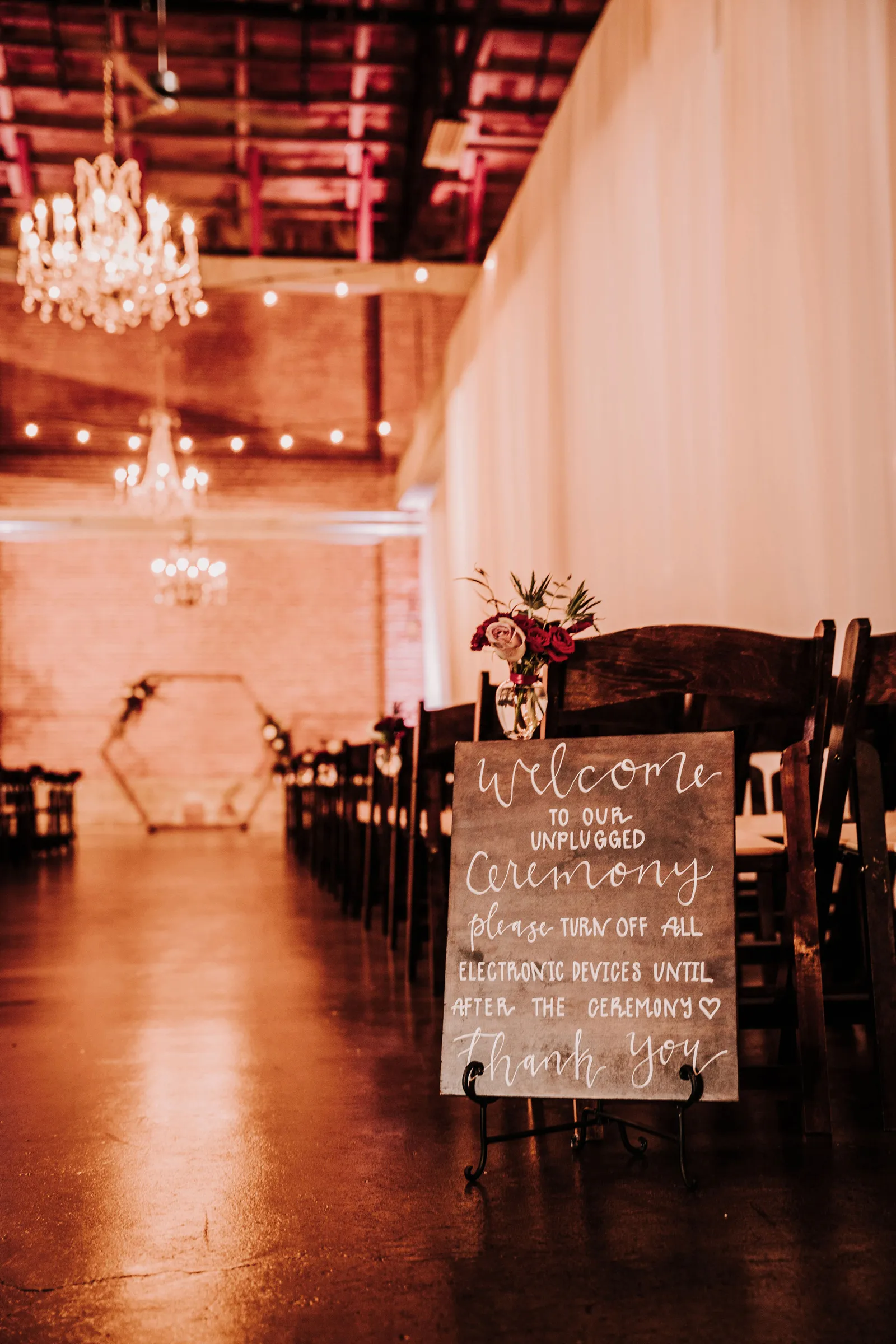 Photo of dimly lit walkway down the aisle.