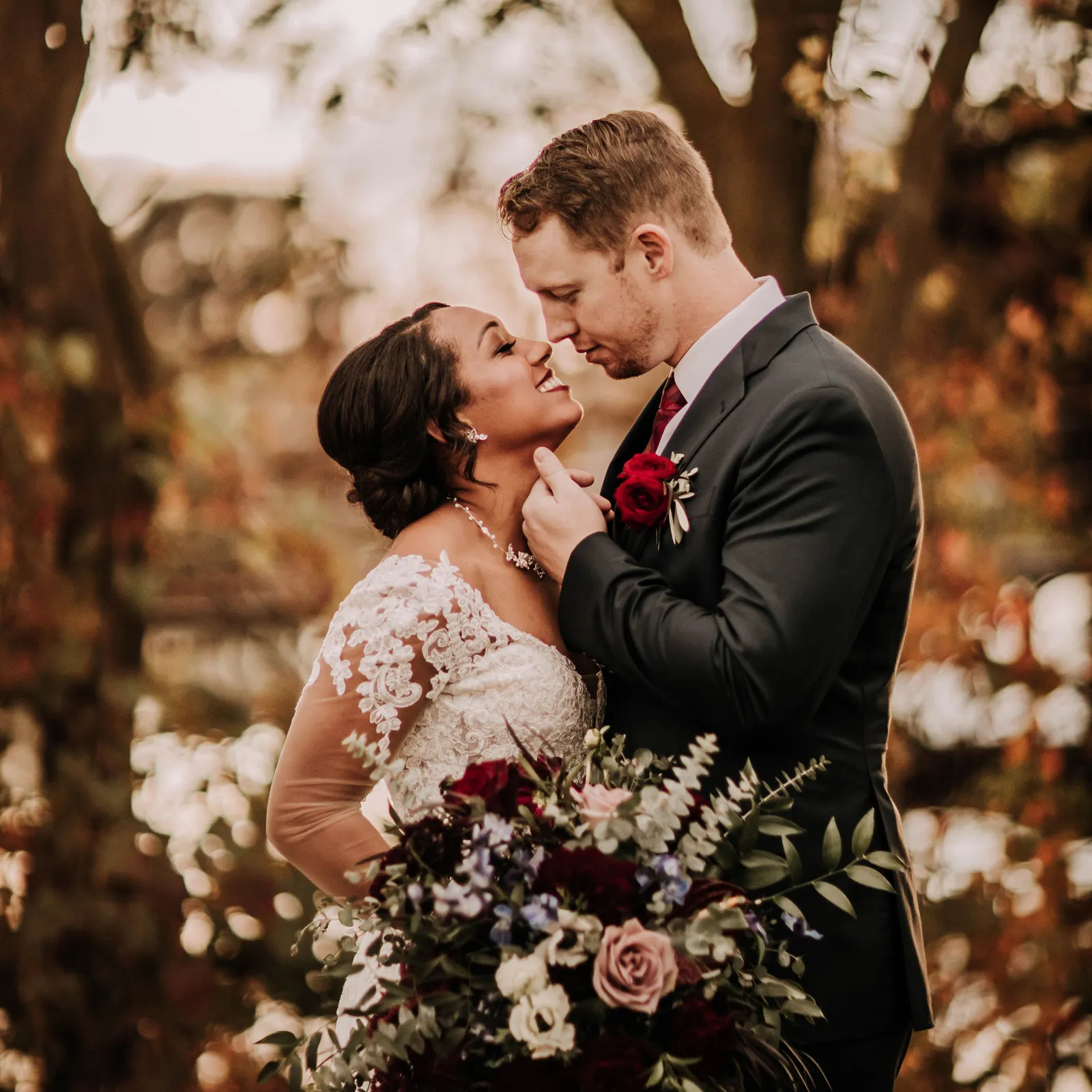 Groom about to kiss his bride as he pinches her chin.