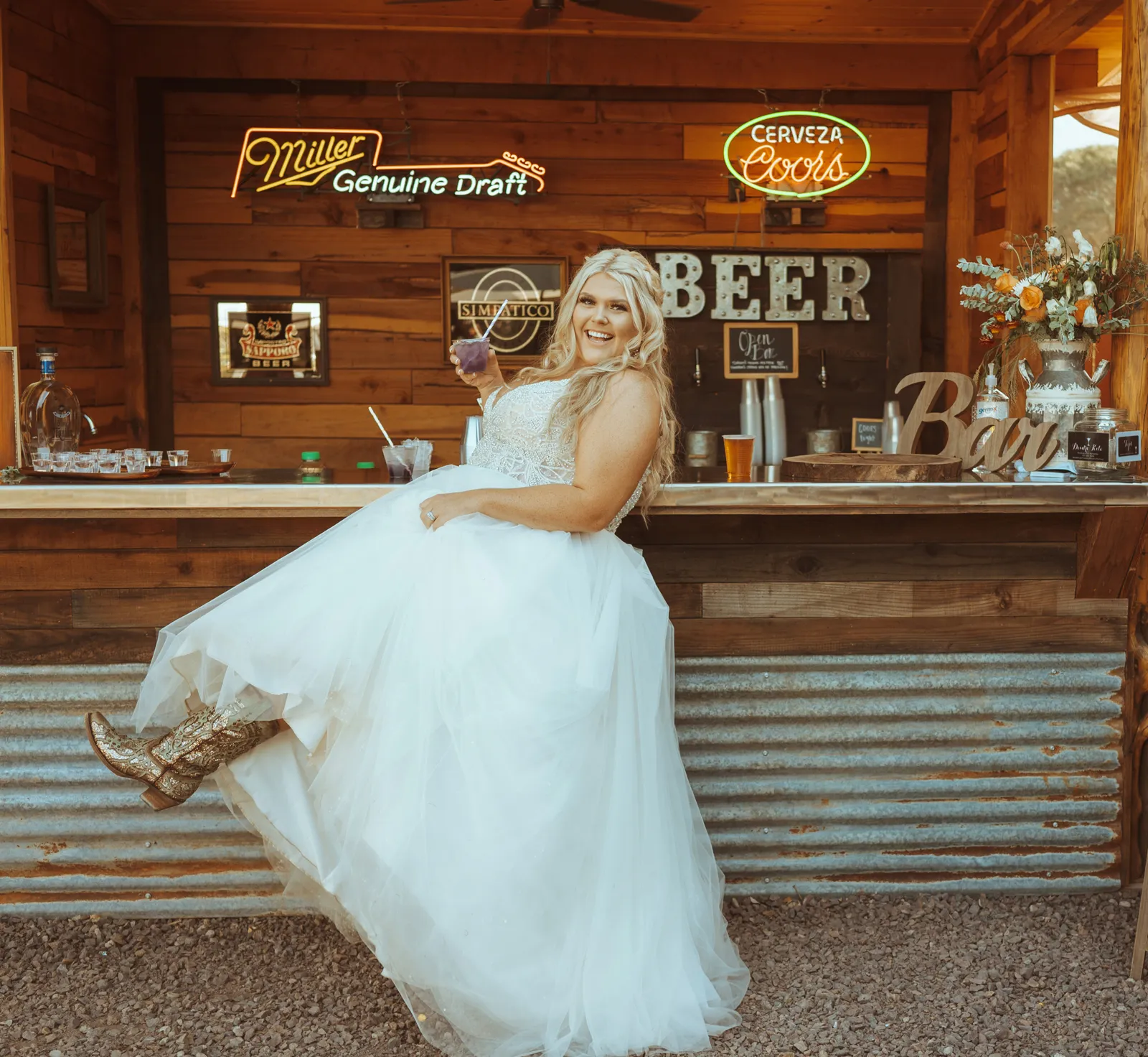 Bride posing and holding her leg out by the bar.