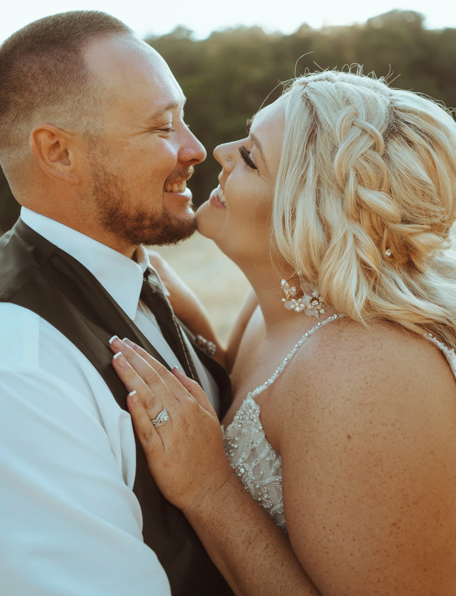 Close up photo of bride and groom about to kiss.