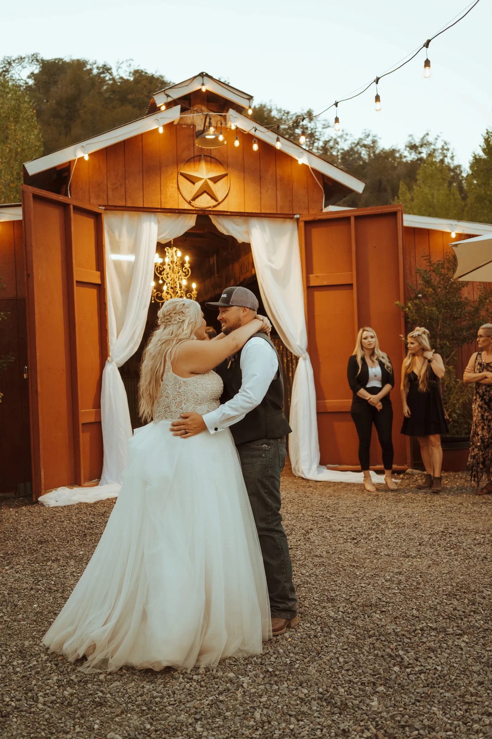 Bride and groom having their first dance outside.