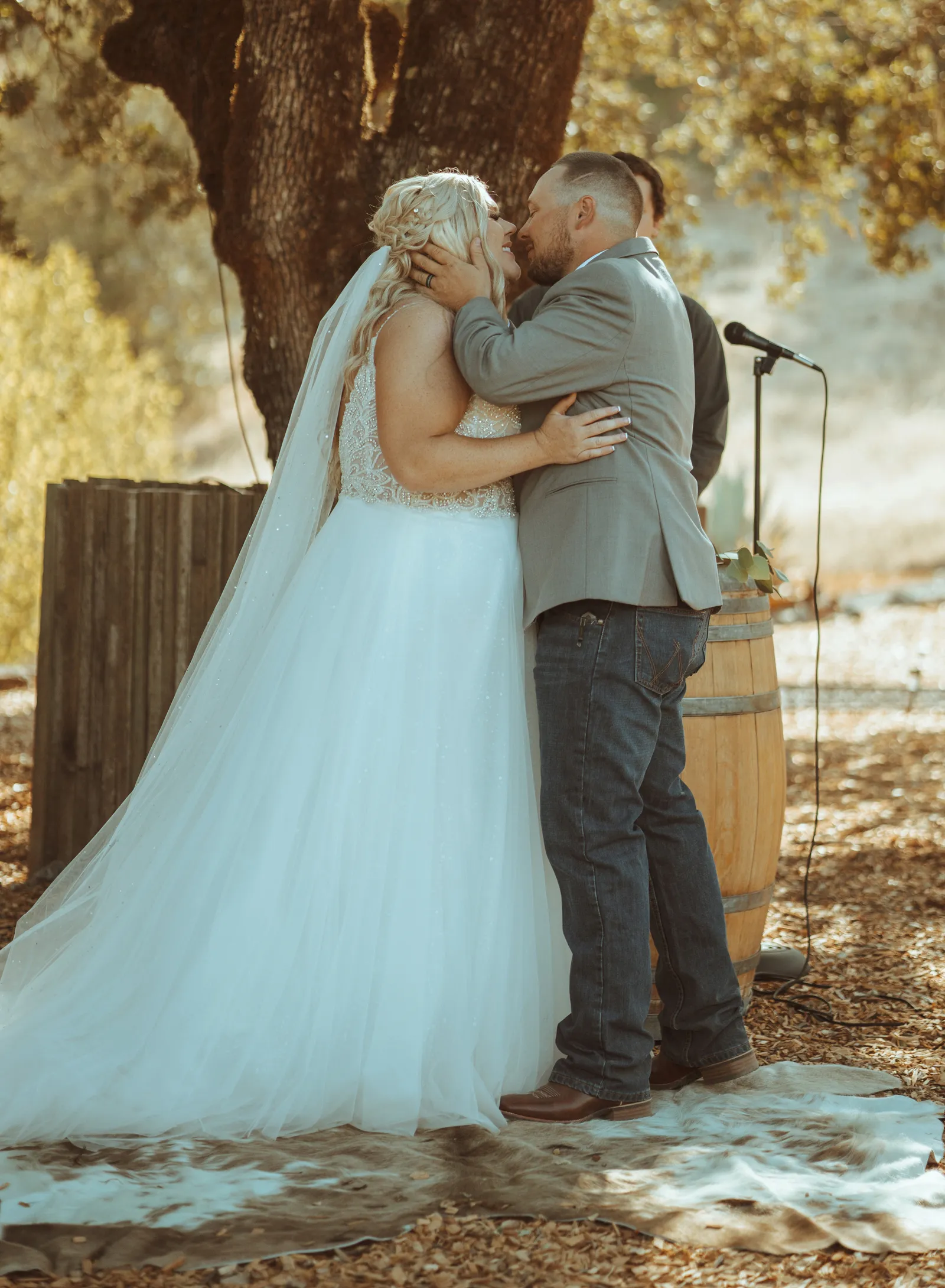 Groom grabbing his bride's face and kissing her at the altar.