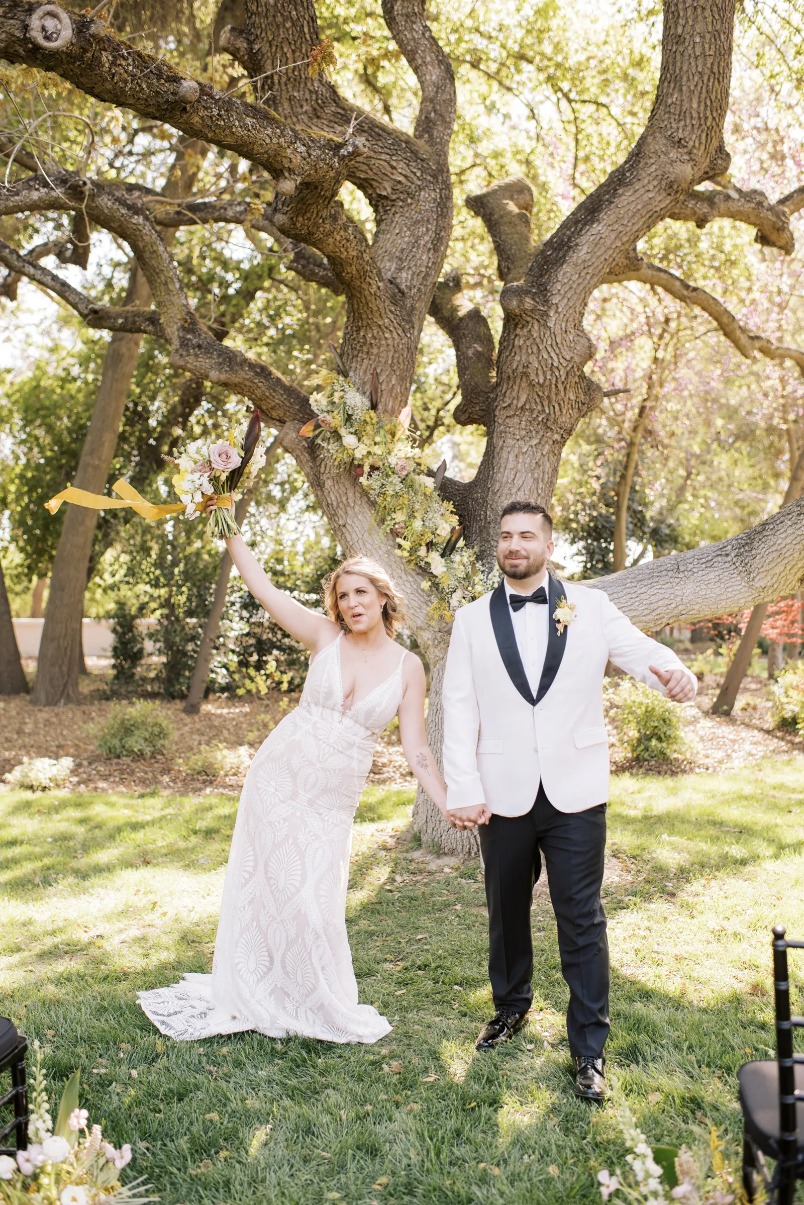 Bride and groom walking and celebrating down the aisle.