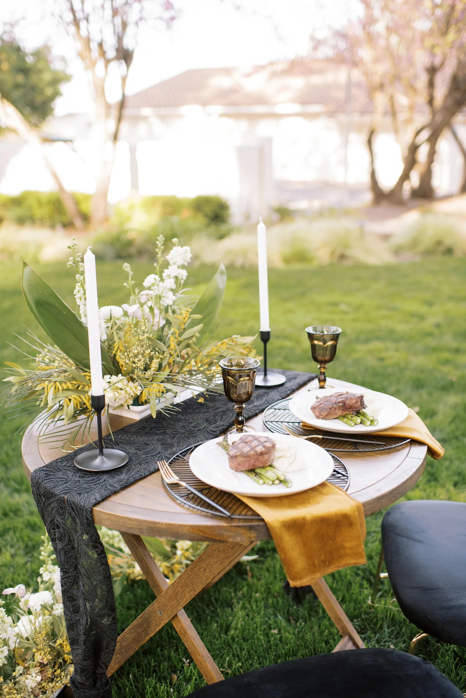 Small round table for two with food on it.