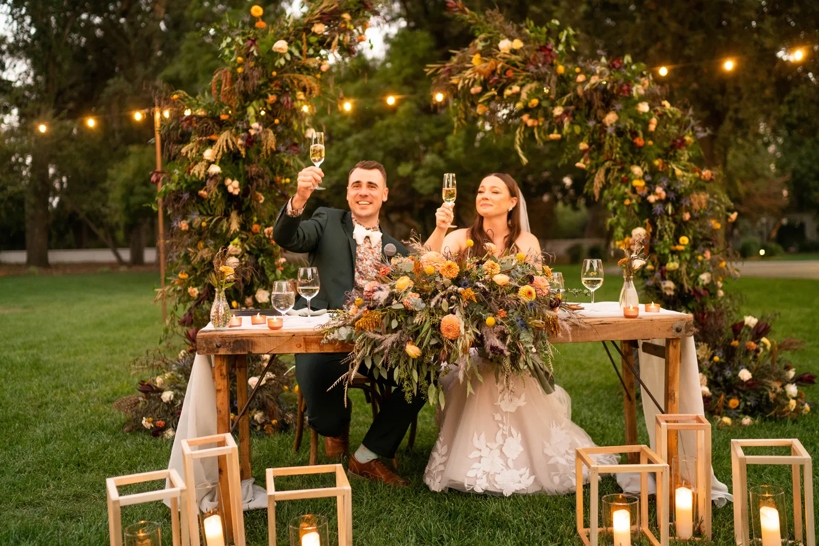 Bride and groom holding their glasses up in a toast.