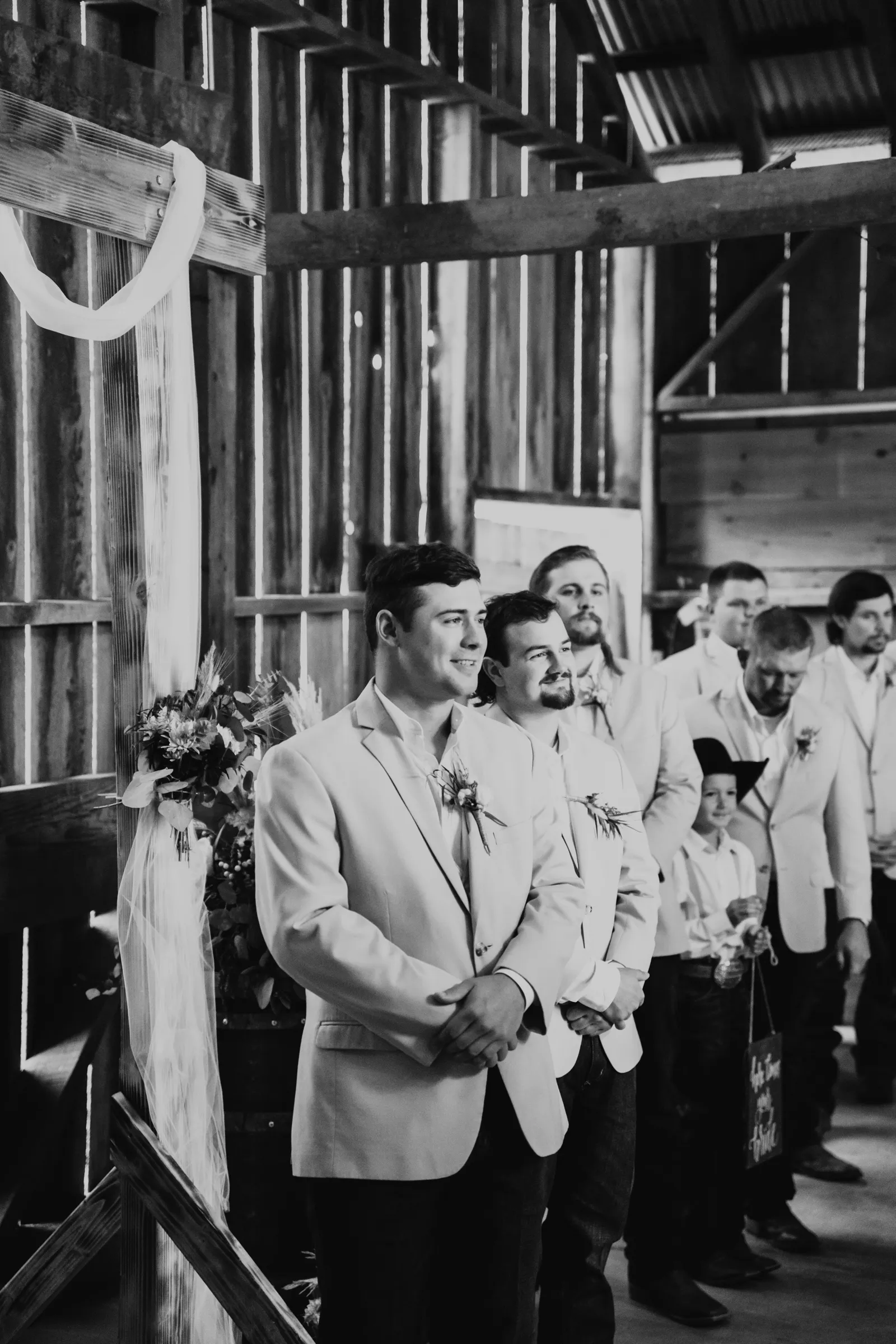 Groom smiling at the altar waiting for his bride.