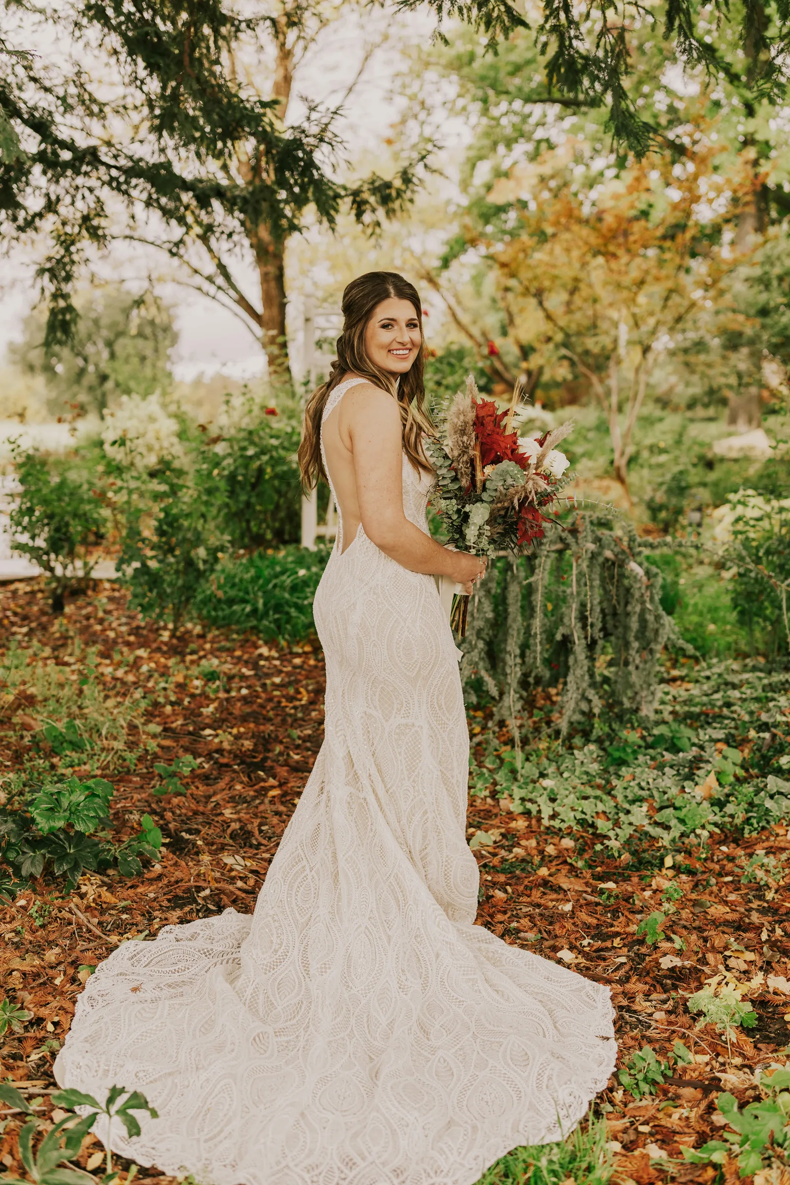 Bride posing with her flowers outside.