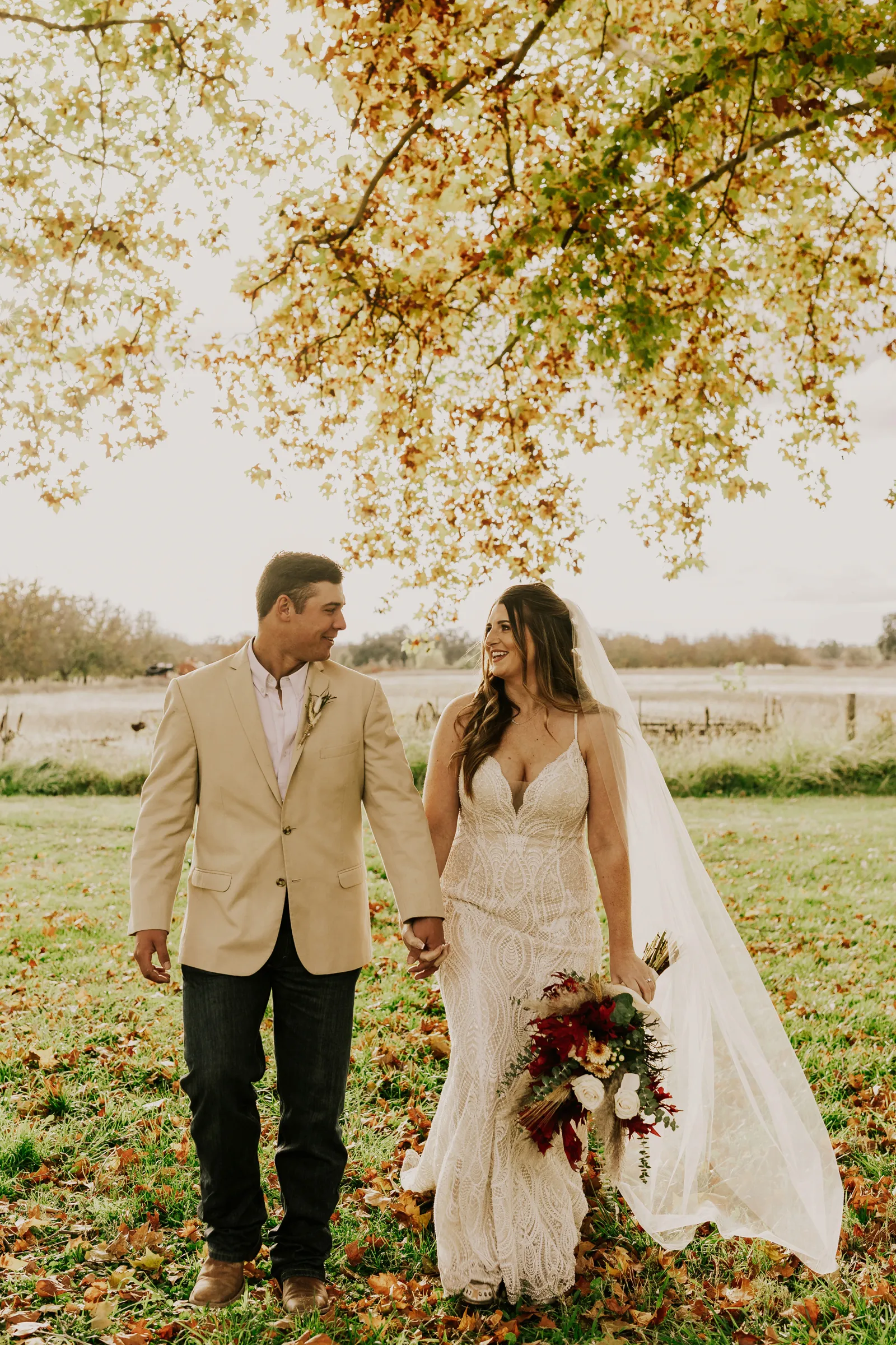 Bride and groom holding hands and walking towards the camera.