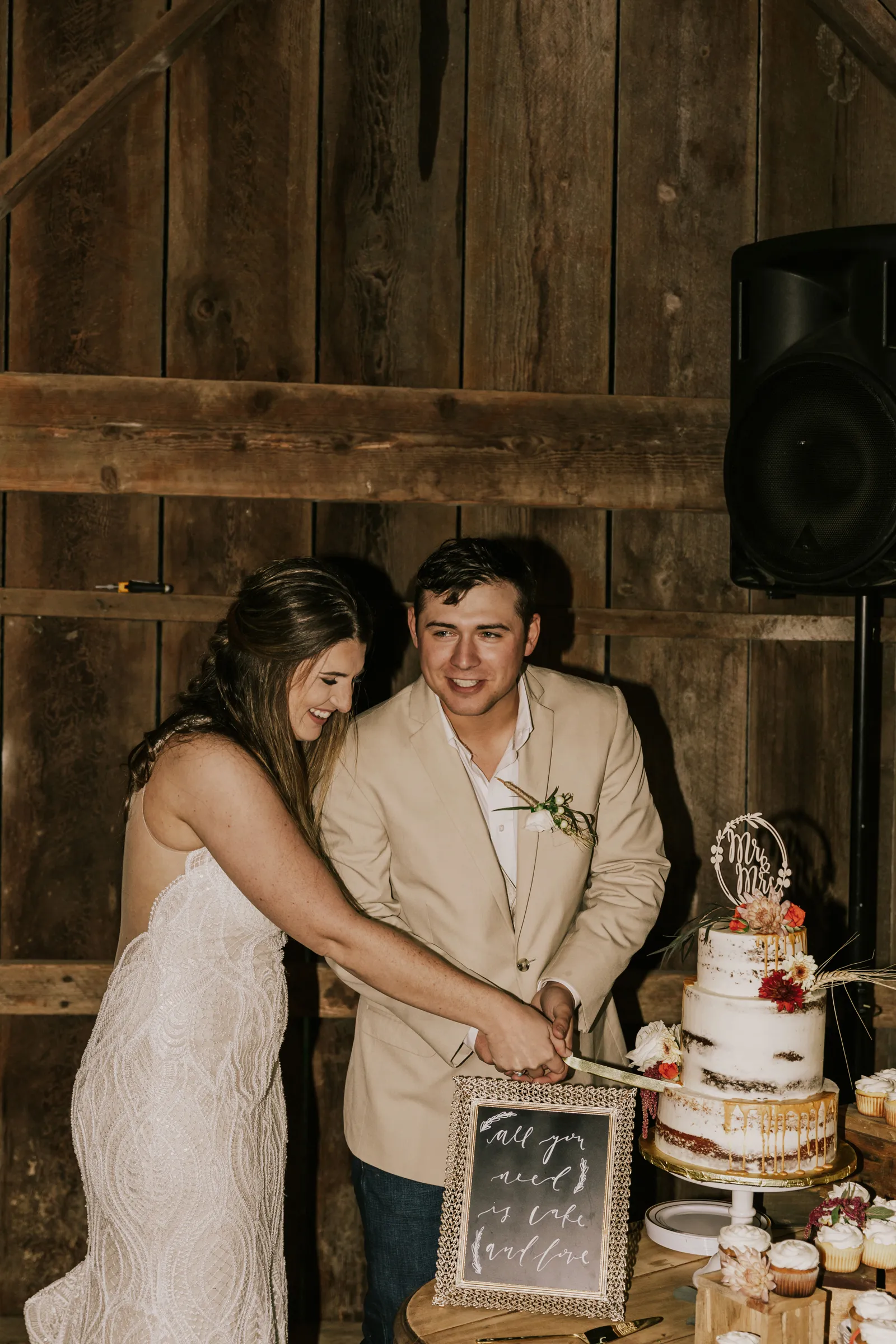 Bride and groom cutting their cake together.