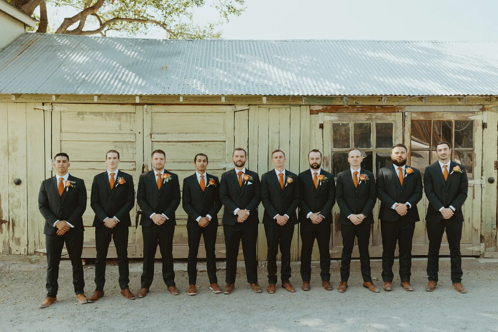 Groom and his groomsmen smiling and posing together.