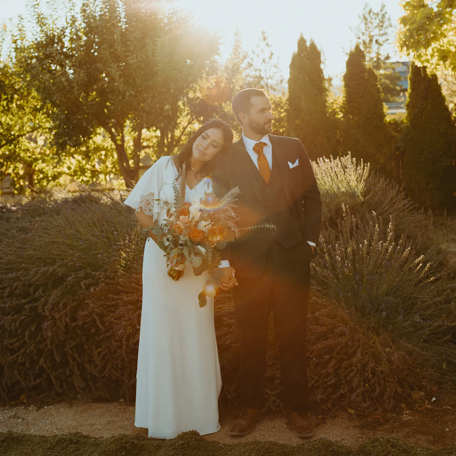 Bride resting her head on her husband's shoulder for photos.