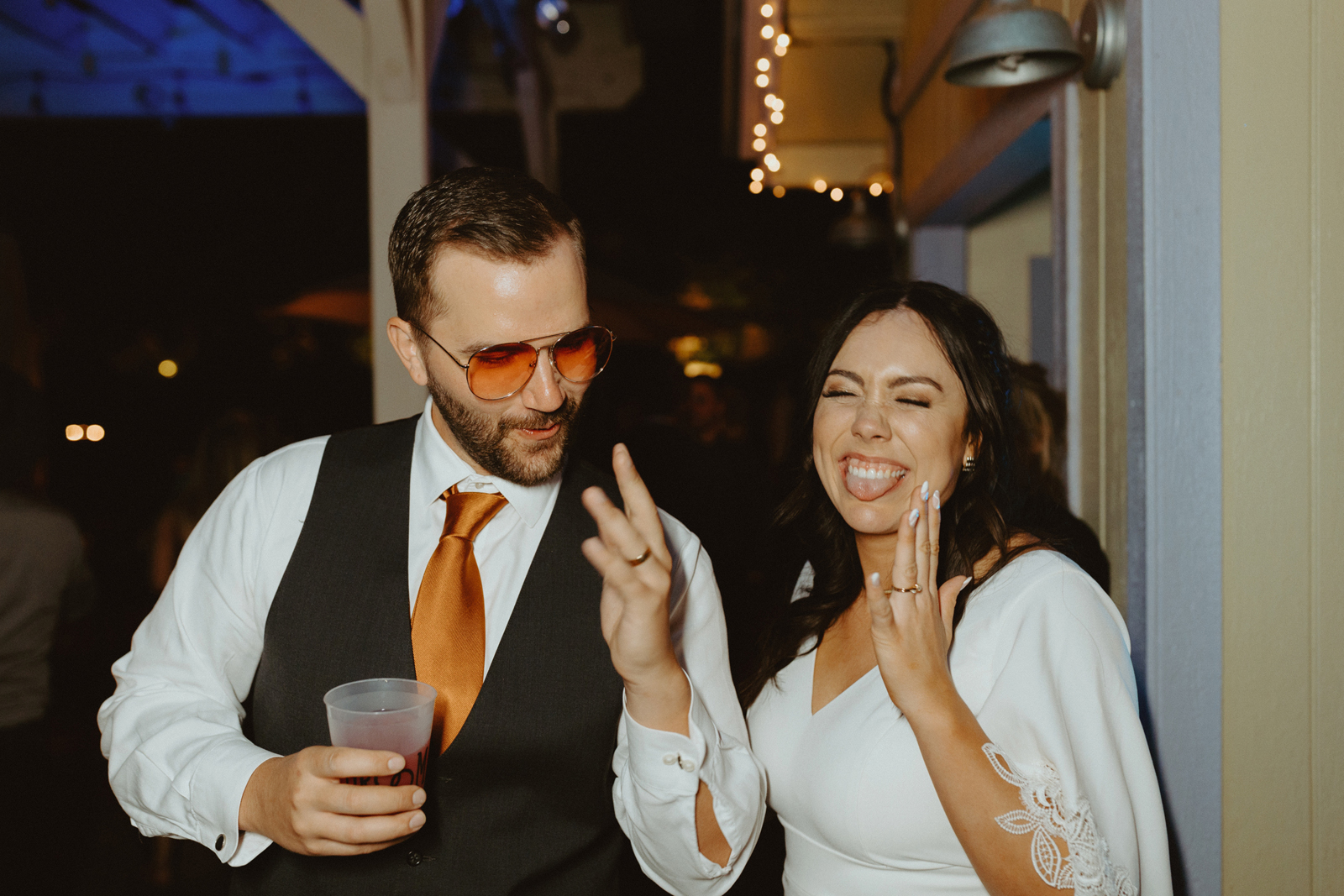 Bride and groom smiling during everyone dancing.