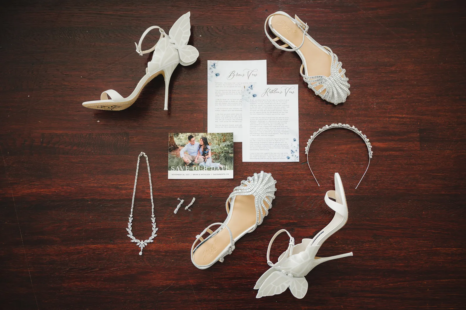 Signage and paperie laid out beside one another along with shoes and jewelry.