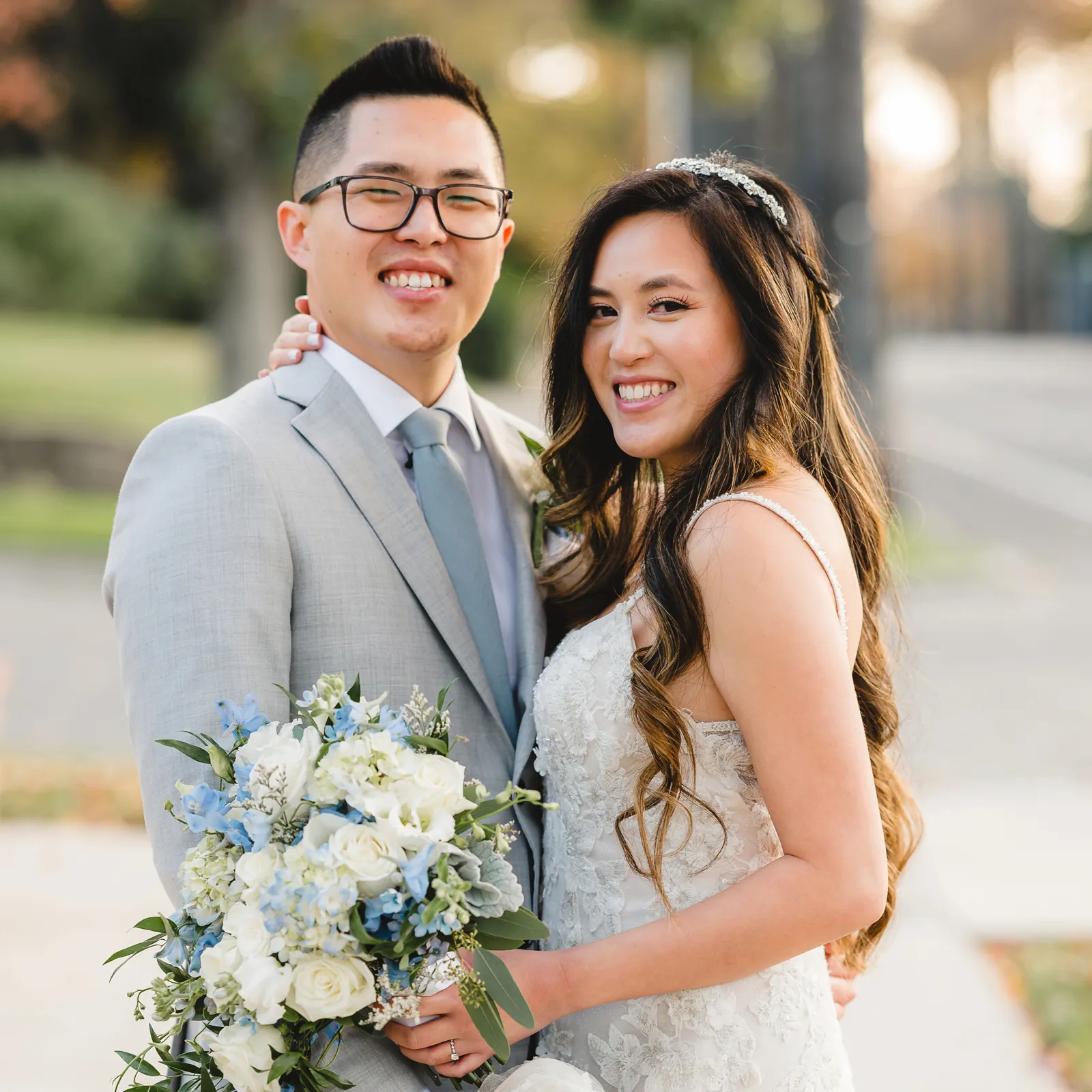 Bride and groom smiling together for a photo.