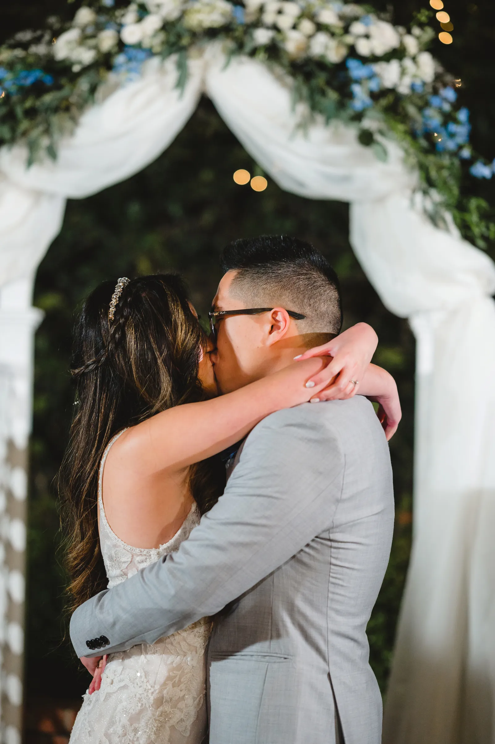 Bride and groom kissing at the altar.