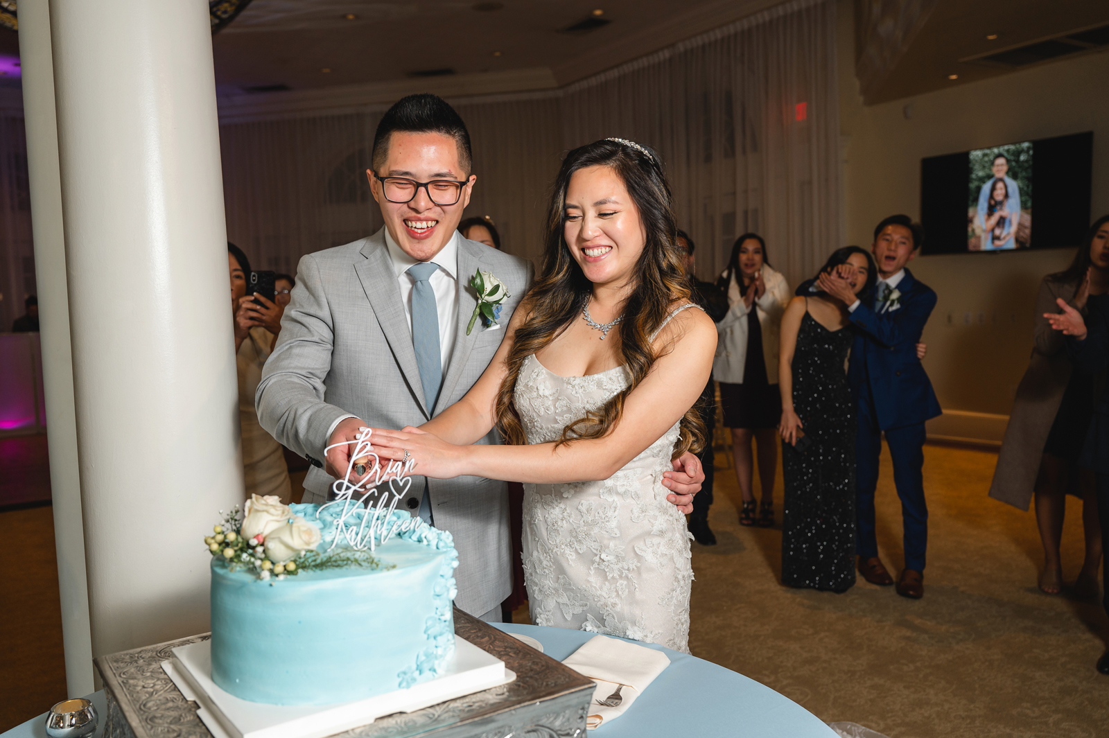 Bride and groom cutting their cake together.