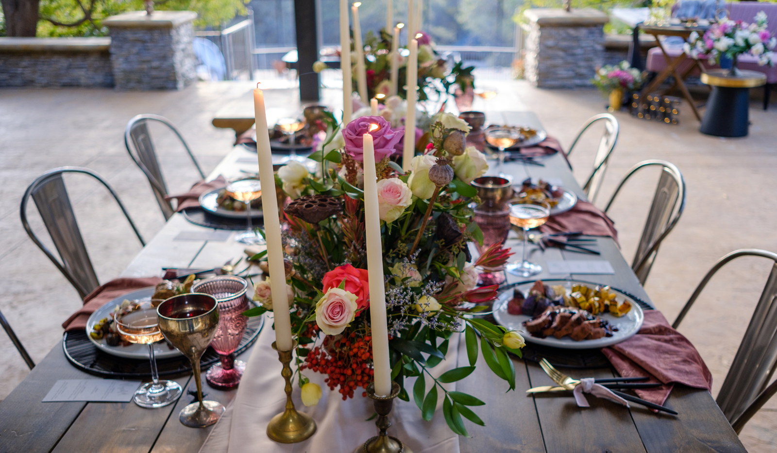 Photo of a long table with candles and flowers.