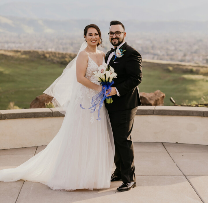 Bride and groom smiling for the camera.