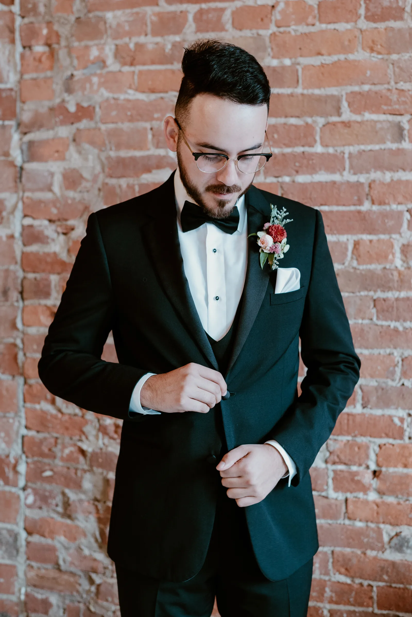 Groom fixing his suit.