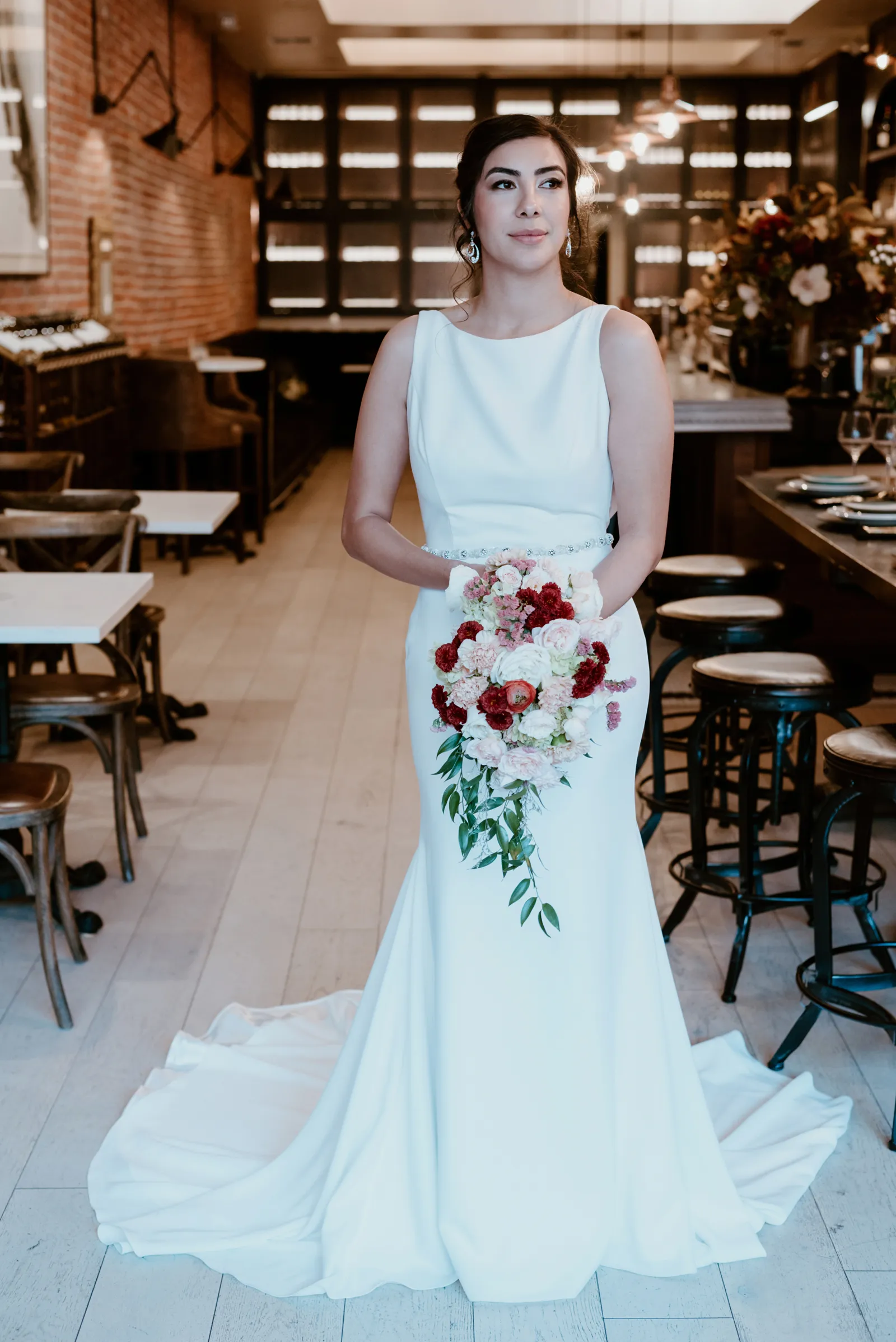 Full body photo of a bride holding her bouquet.