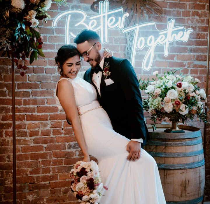 Groom tilting his bride about to kiss her.