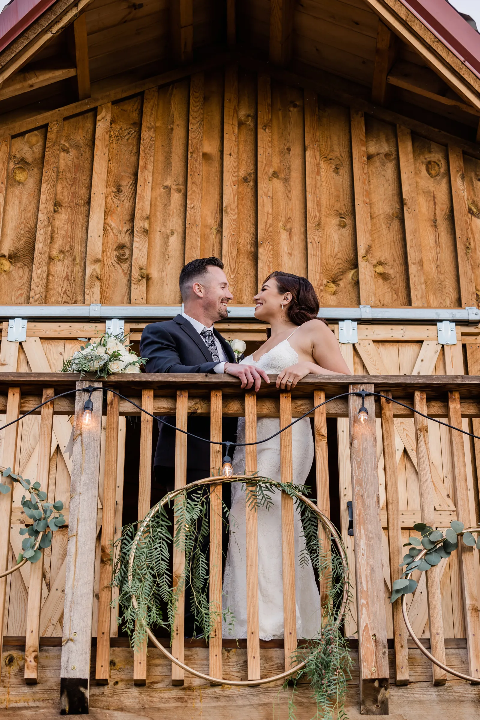 Bride and groom posing on the balcony of Richard's Ranch