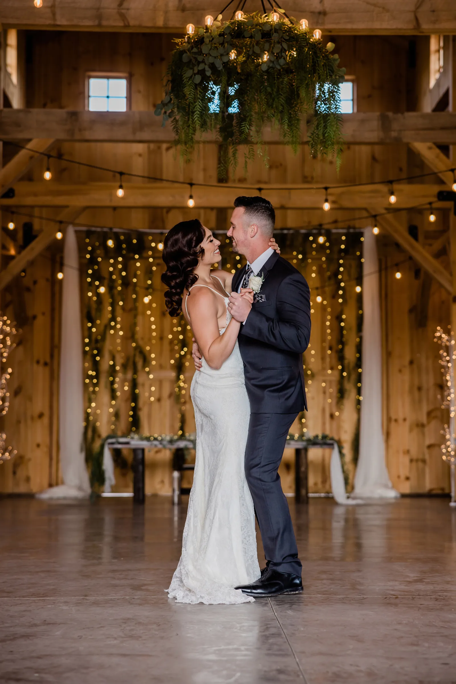 Bride and groom dancing together in the empty reception venue.