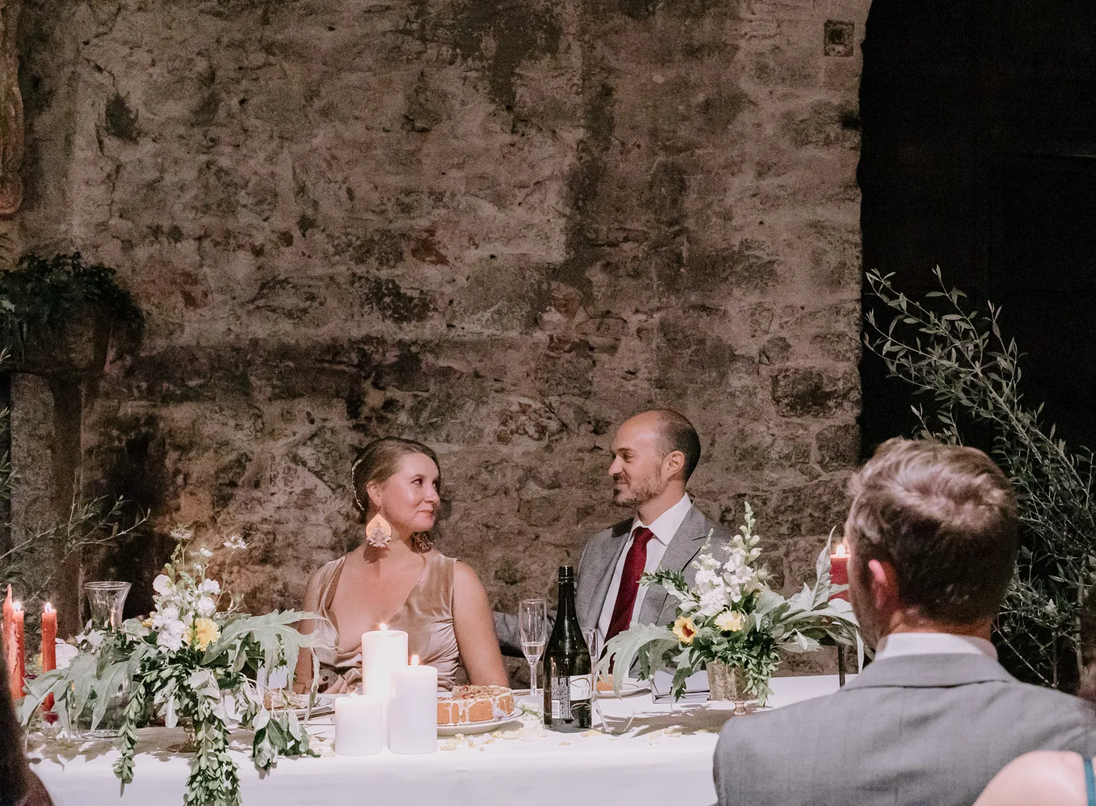 Bride and groom sitting a their sweetheart table.