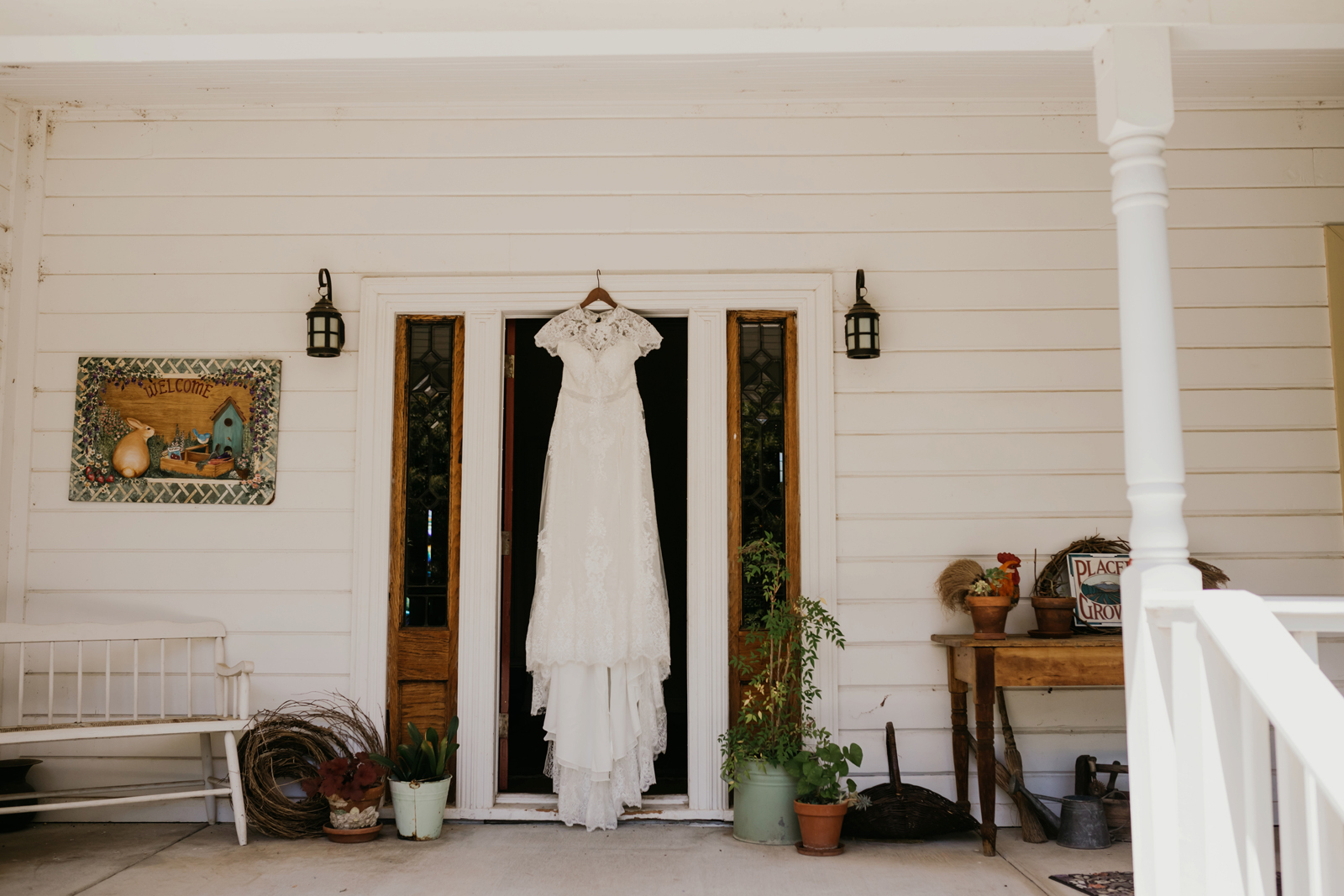 Wedding dress hanging up in the front of the house.