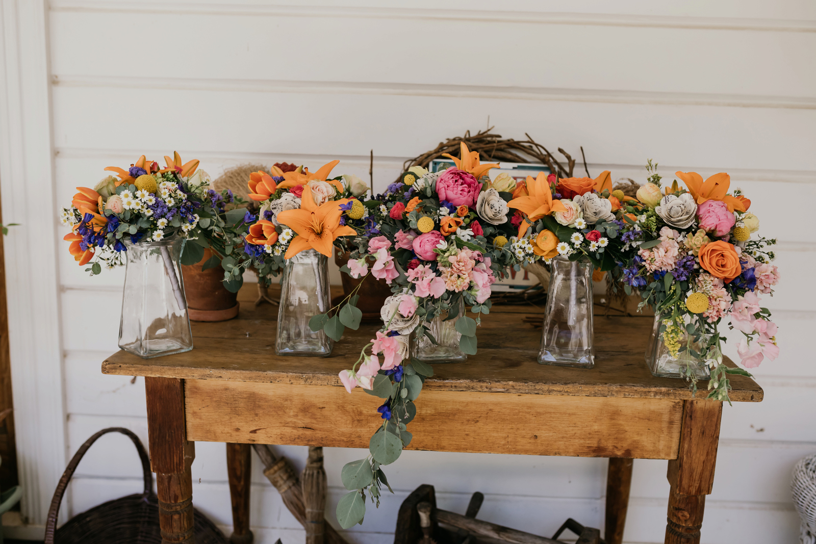 Florals sitting atop a table, in jars.