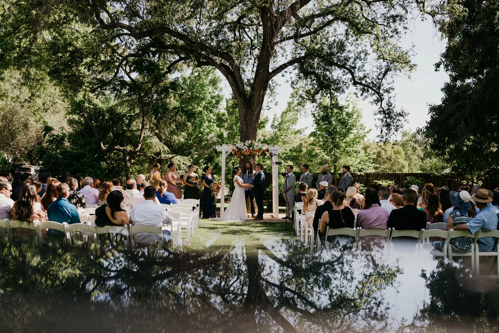 Photo of the wedding venue with guests seated, waiting to hear from the officiant.