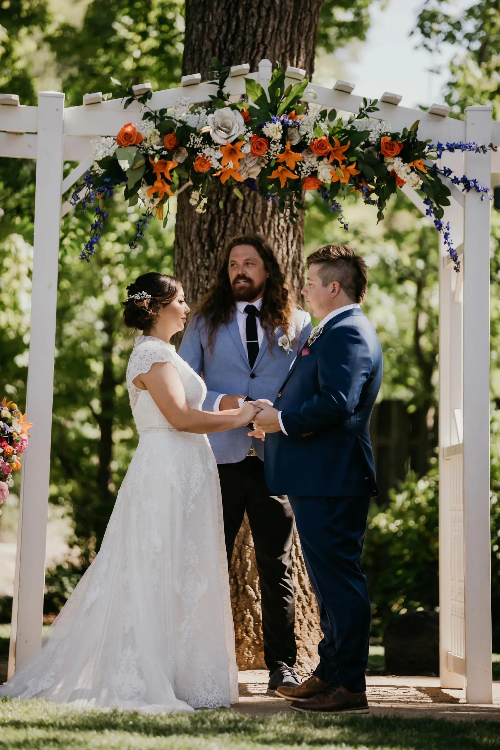 Bride and groom holding hands at the altar.