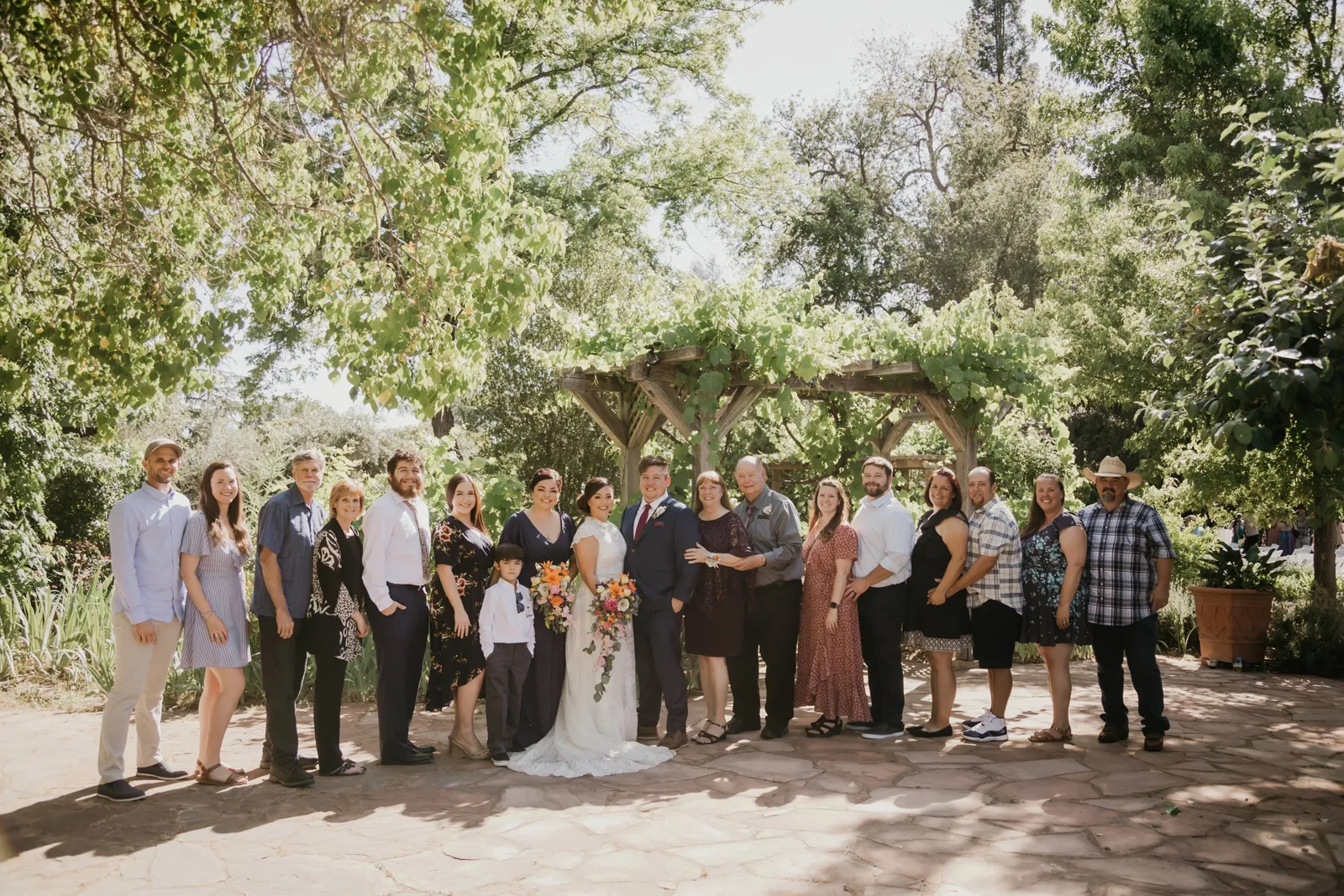 Bride groom posing with their guests and bridal party.