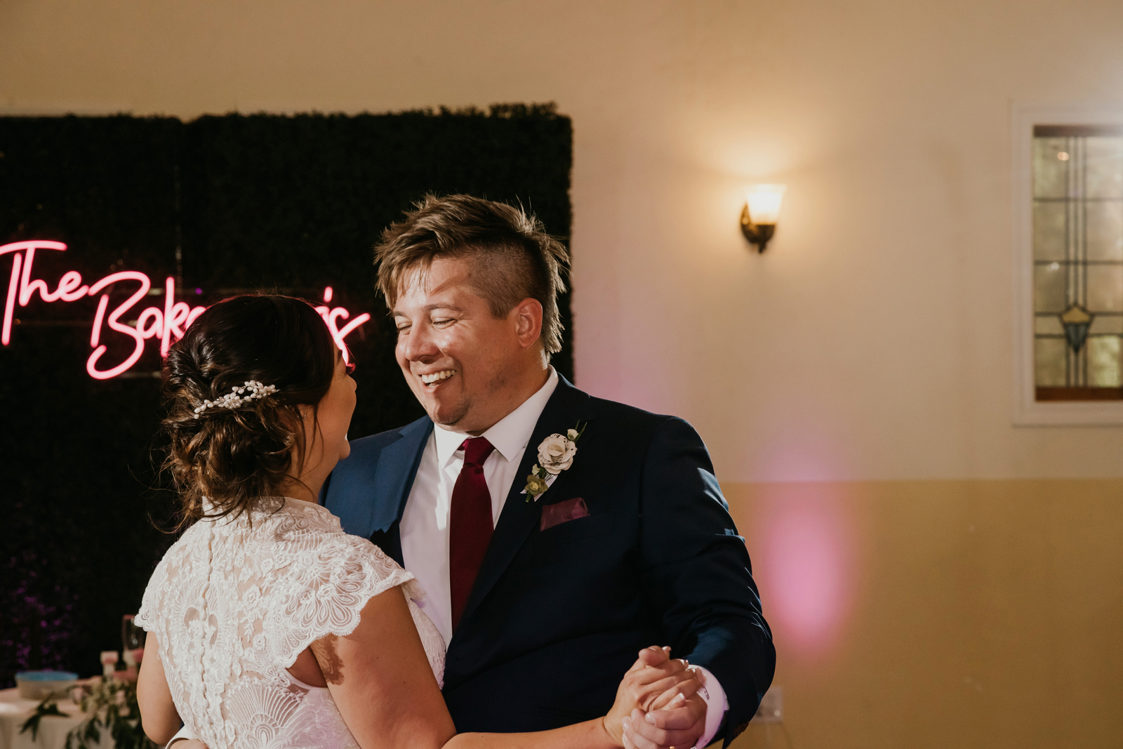 Newlywed groom smiling at his wife.