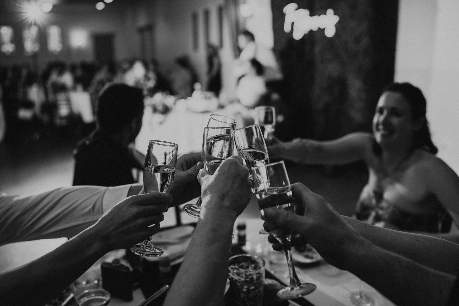 Black and white photo of the guests cheersing.