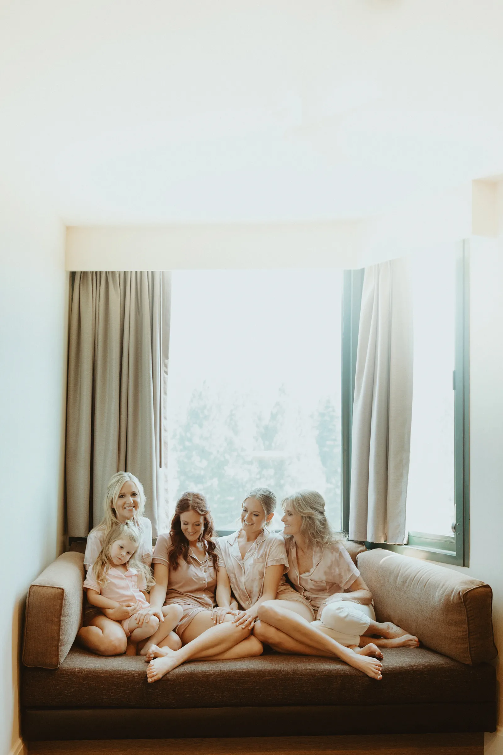 Bride and her bridal party smiling before they get ready.